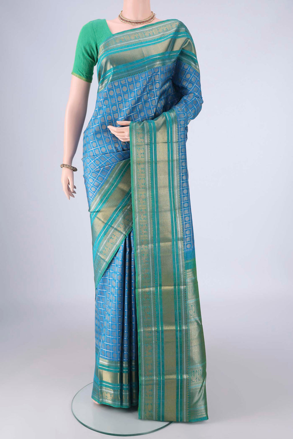 Pure Silk Pure Zari Blue Kanjivaram Saree with Checked design on the body and Zari Border.  displayed on a mannequin