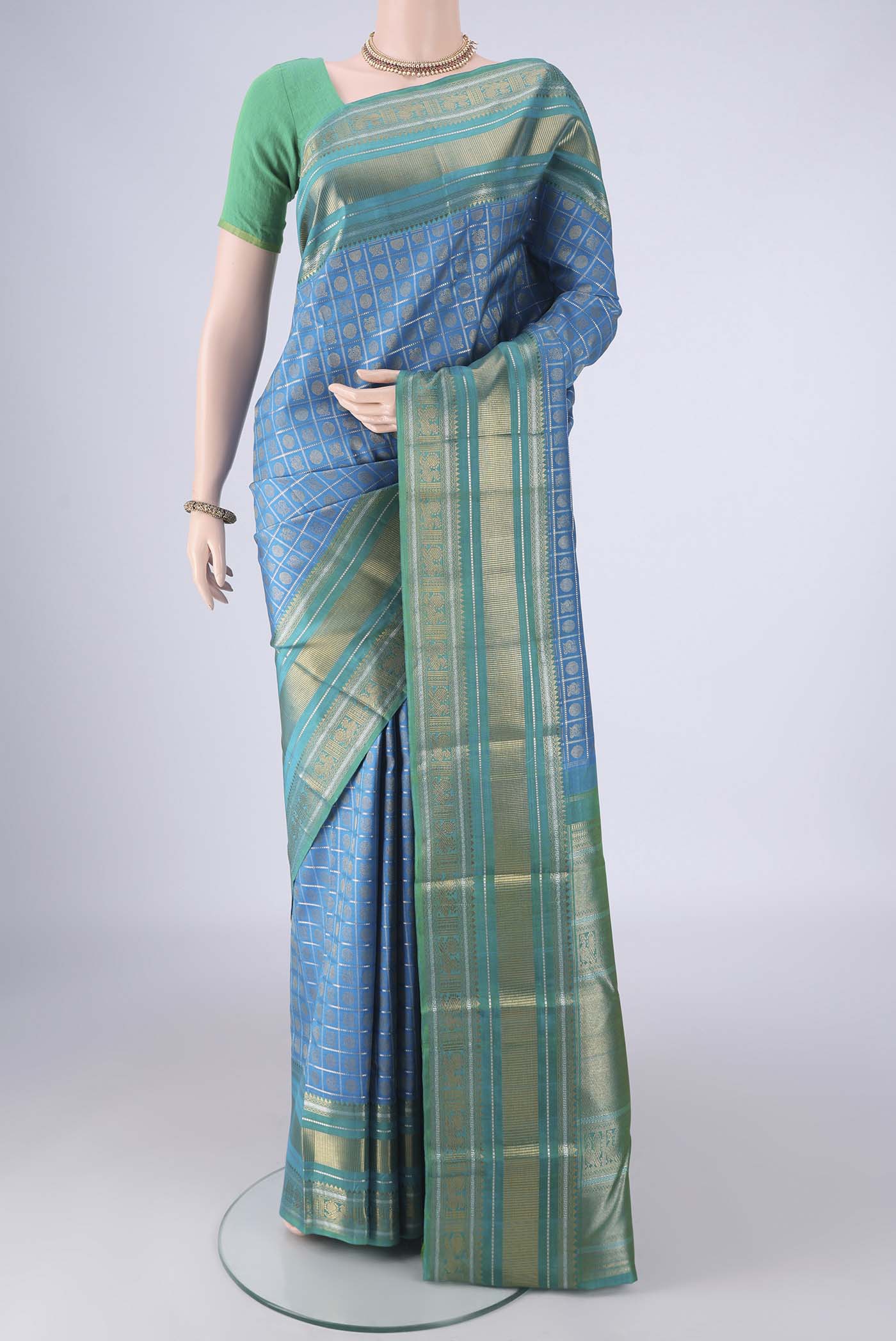 Pure Silk Pure Zari Blue Kanjivaram Saree with Checked design on the body and Zari Border.  displayed on a mannequin