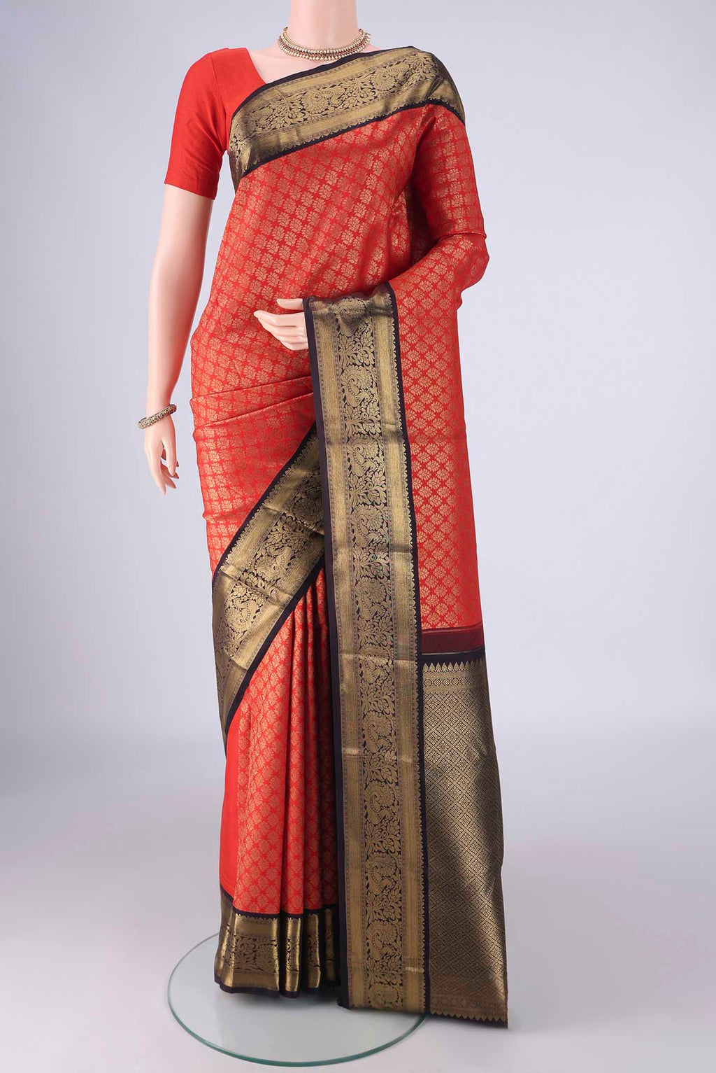 Pure Silk Pure Zari Red Kanjivaram Saree with Zari Brocade on the body and Zari Border.  displayed on a mannequin