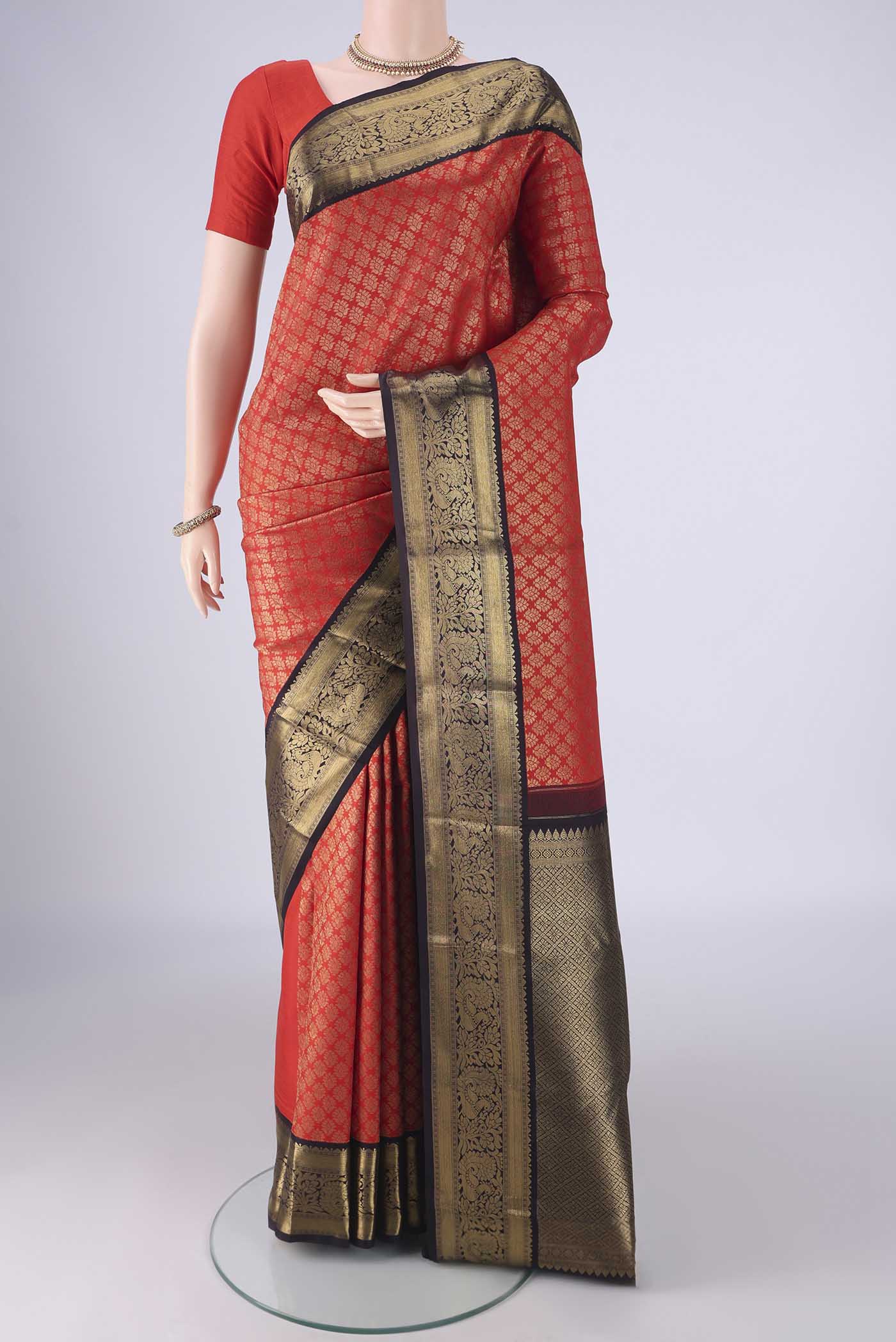 Pure Silk Pure Zari Red Kanjivaram Saree with Zari Brocade on the body and Zari Border.  displayed on a mannequin