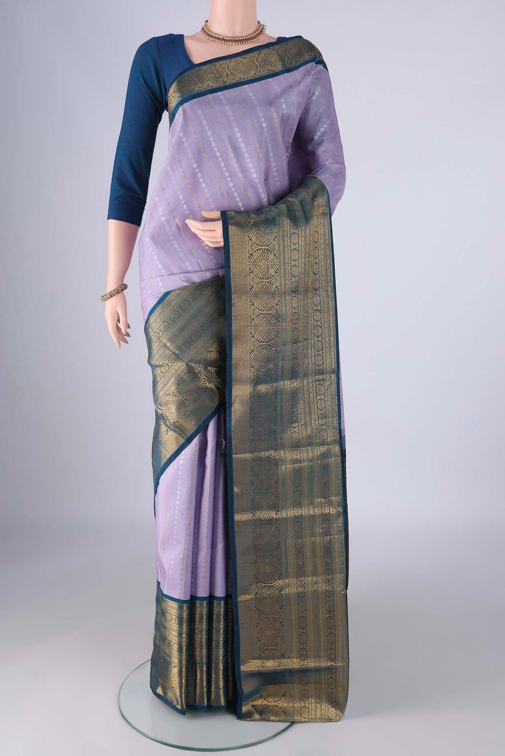 Pure Silk Pure Zari Lavender Kanchipuram Saree with Zari Butta on the body and Zari Border.  displayed on a mannequin
