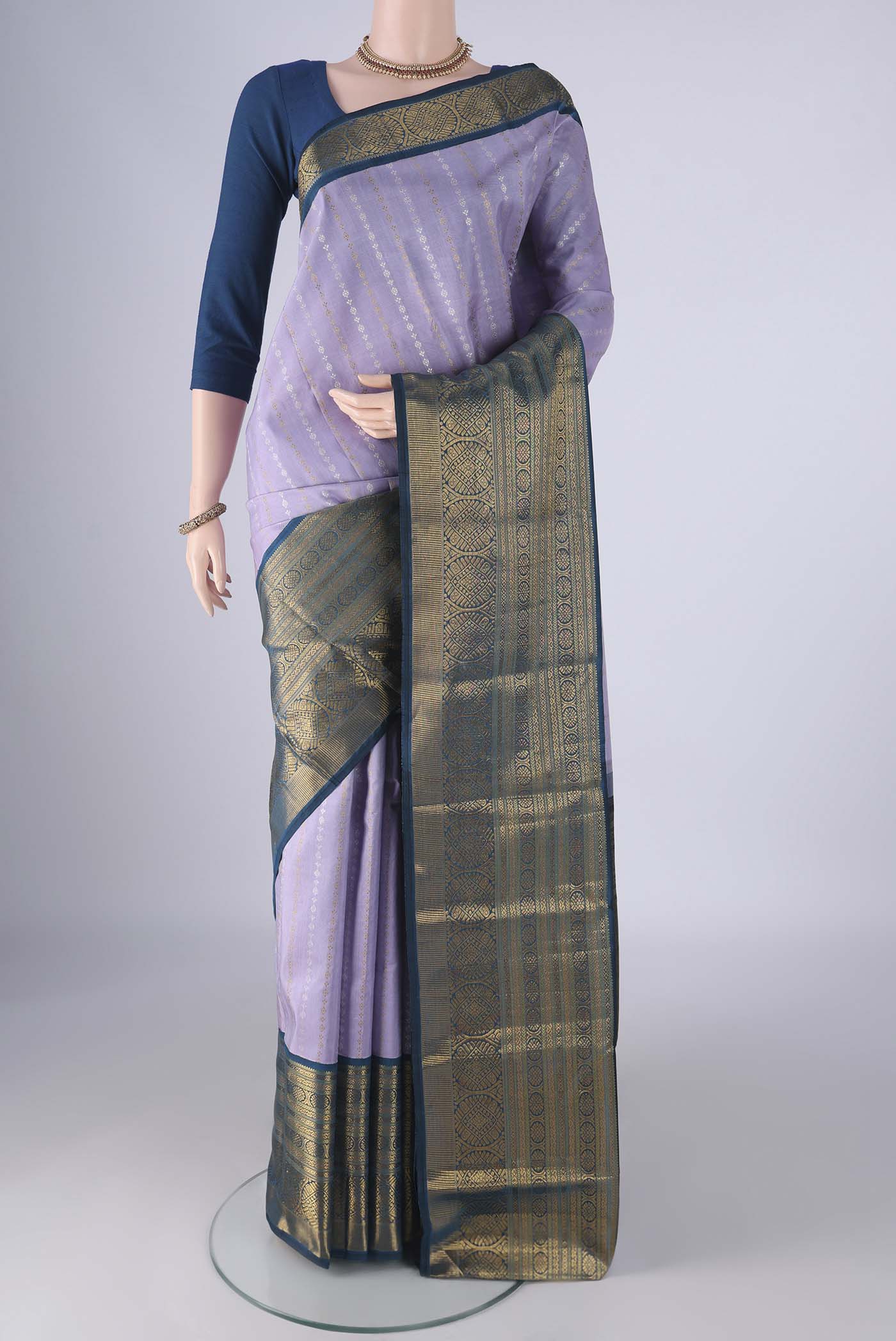 Pure Silk Pure Zari Lavender Kanchipuram Saree with Zari Butta on the body and Zari Border.  displayed on a mannequin