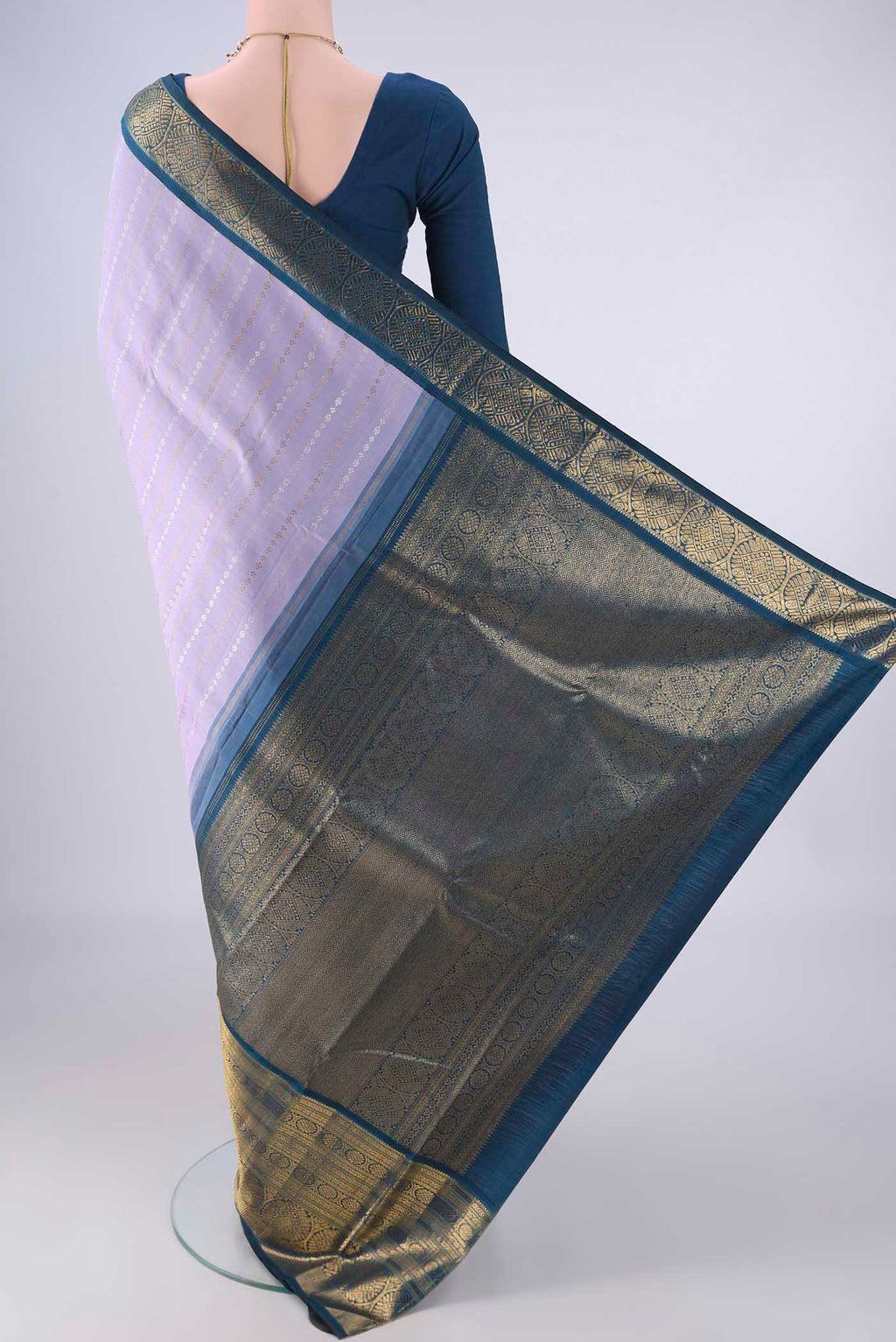 Flat view of Pure Silk Pure Zari Lavender Kanchipuram Saree with Zari Butta on the body and Zari Border. 