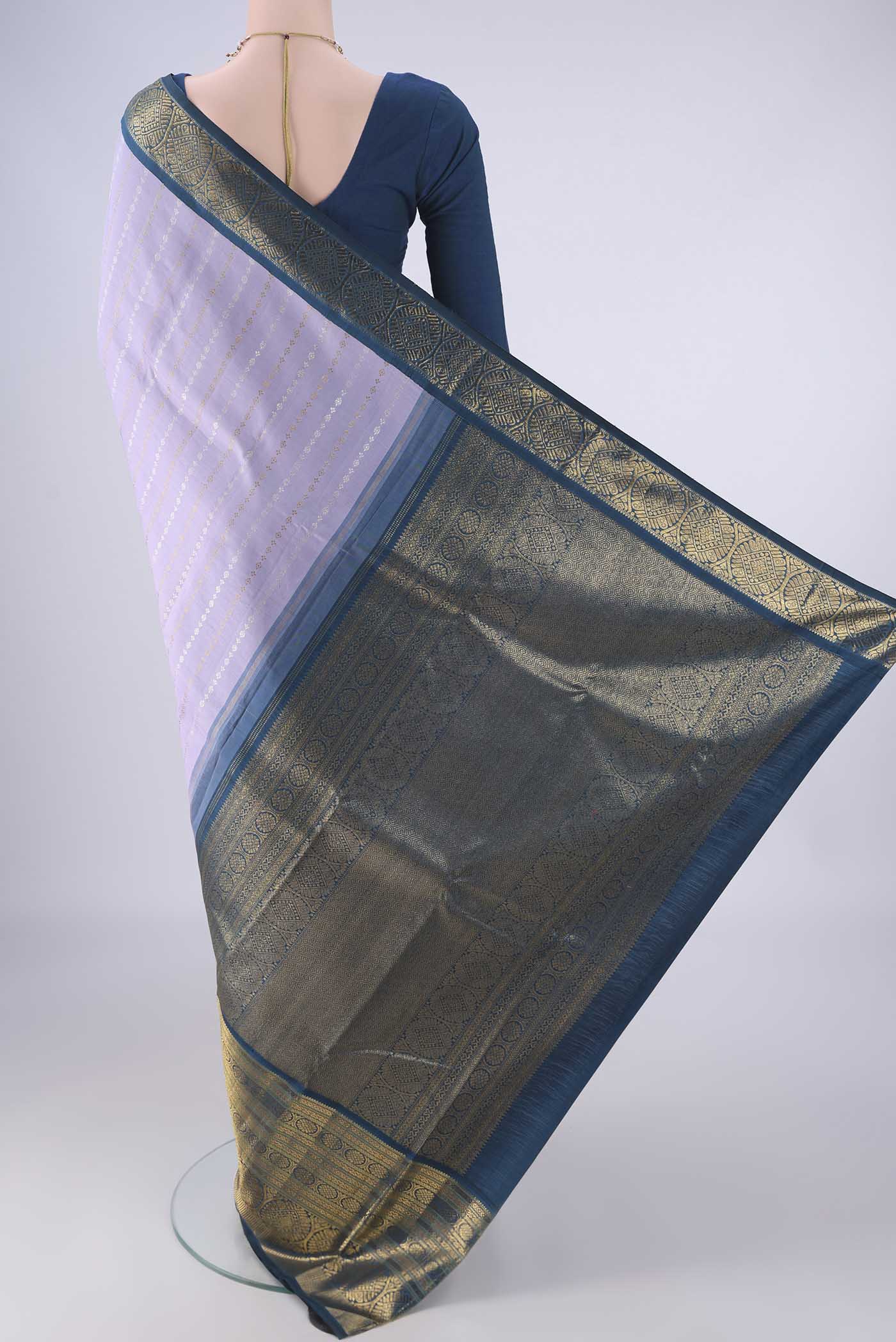Flat view of Pure Silk Pure Zari Lavender Kanchipuram Saree with Zari Butta on the body and Zari Border. 