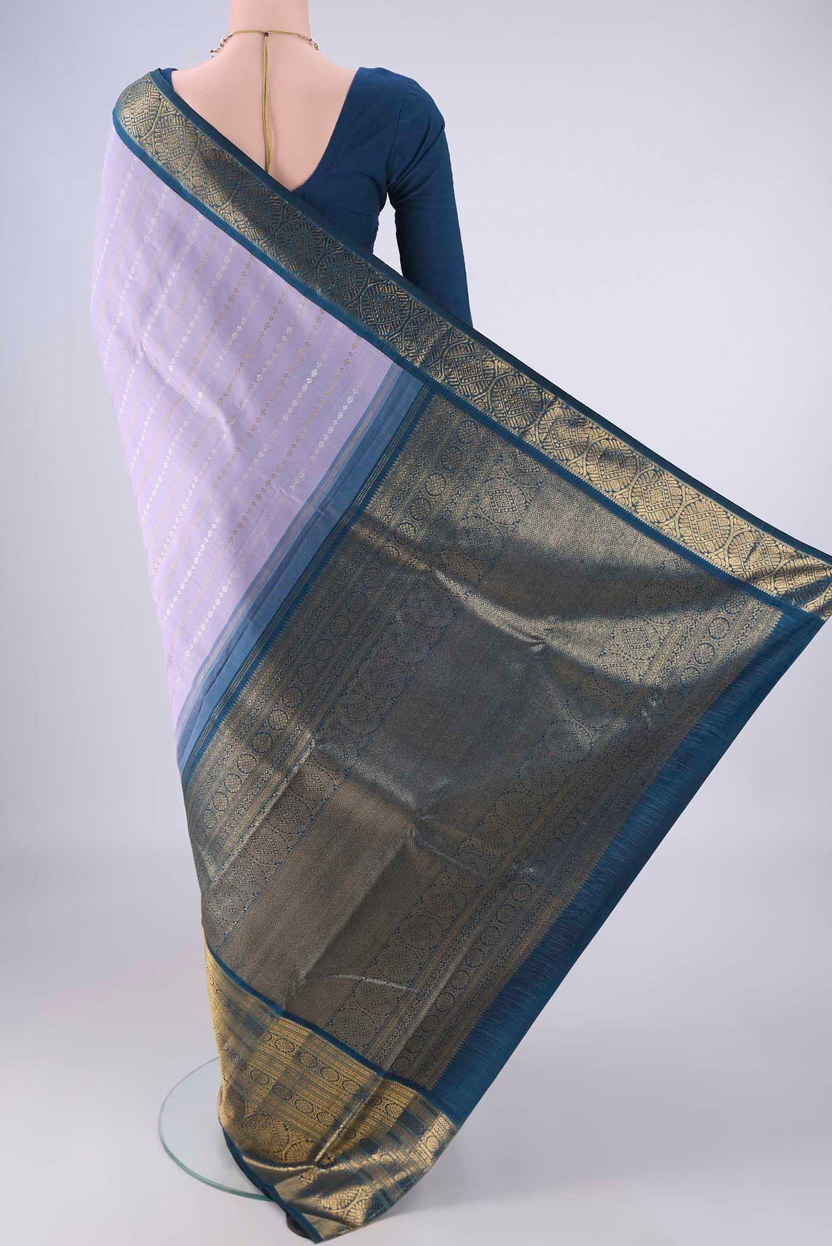 Flat view of Pure Silk Pure Zari Lavender Kanchipuram Saree with Zari Butta on the body and Zari Border. 