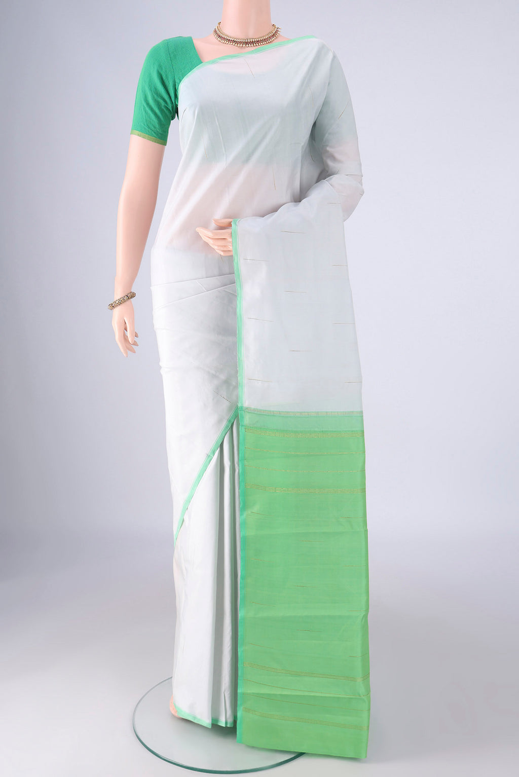 Sky Blue Kanjivaram Silk Saree with Zari Butta on the body and Plain Border.  displayed on a mannequin