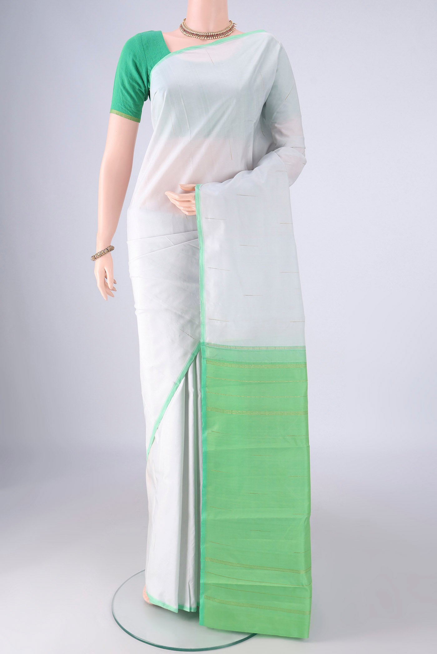 Sky Blue Kanjivaram Silk Saree with Zari Butta on the body and Plain Border.  displayed on a mannequin