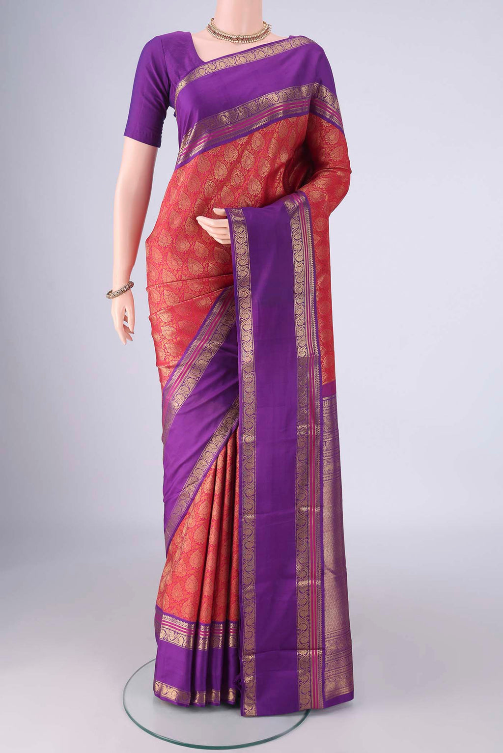 Pure Silk Pure Zari Red Kanjivaram Saree with Zari Brocade on the body and Zari Border.  displayed on a mannequin