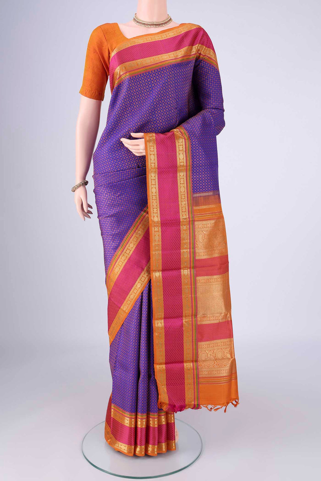 Violet Kanjivaram Silk Saree with Jacquard design on the body and Zari Border.  displayed on a mannequin