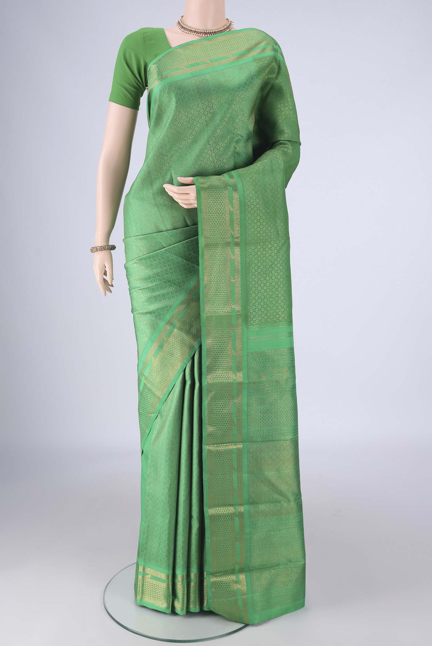 Pure Silk Pure Zari Green Kanjivaram Saree with Zari Brocade on the body and Zari Border.  displayed on a mannequin