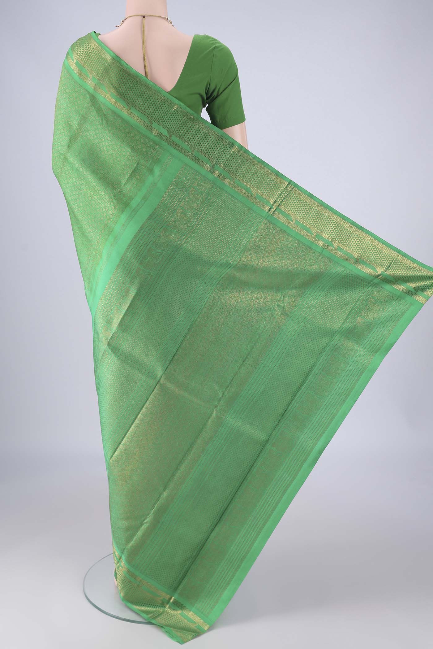 Flat view of Pure Silk Pure Zari Green Kanjivaram Saree with Zari Brocade on the body and Zari Border. 