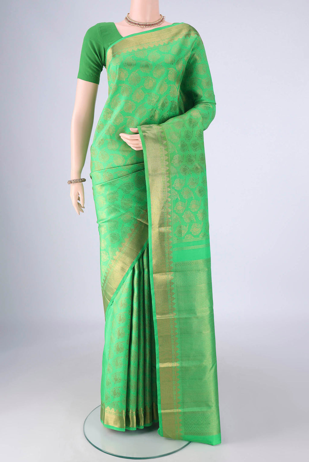 Pure Silk Pure Zari Green Kanjivaram Saree with Zari Brocade on the body and Zari Border.  displayed on a mannequin