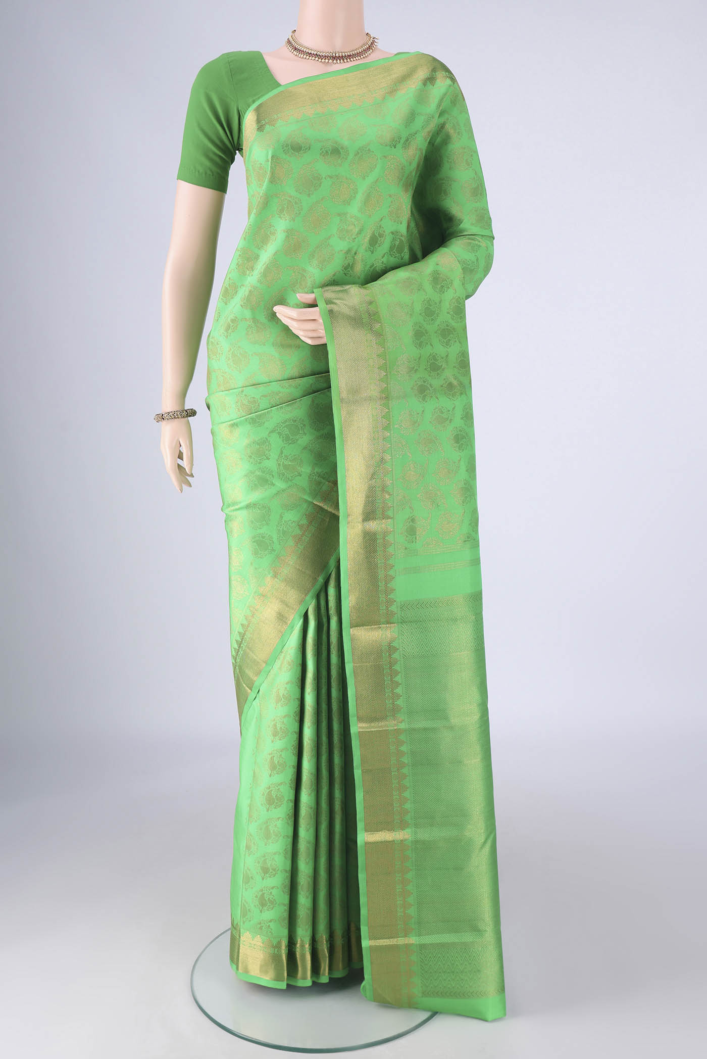 Pure Silk Pure Zari Green Kanjivaram Saree with Zari Brocade on the body and Zari Border.  displayed on a mannequin