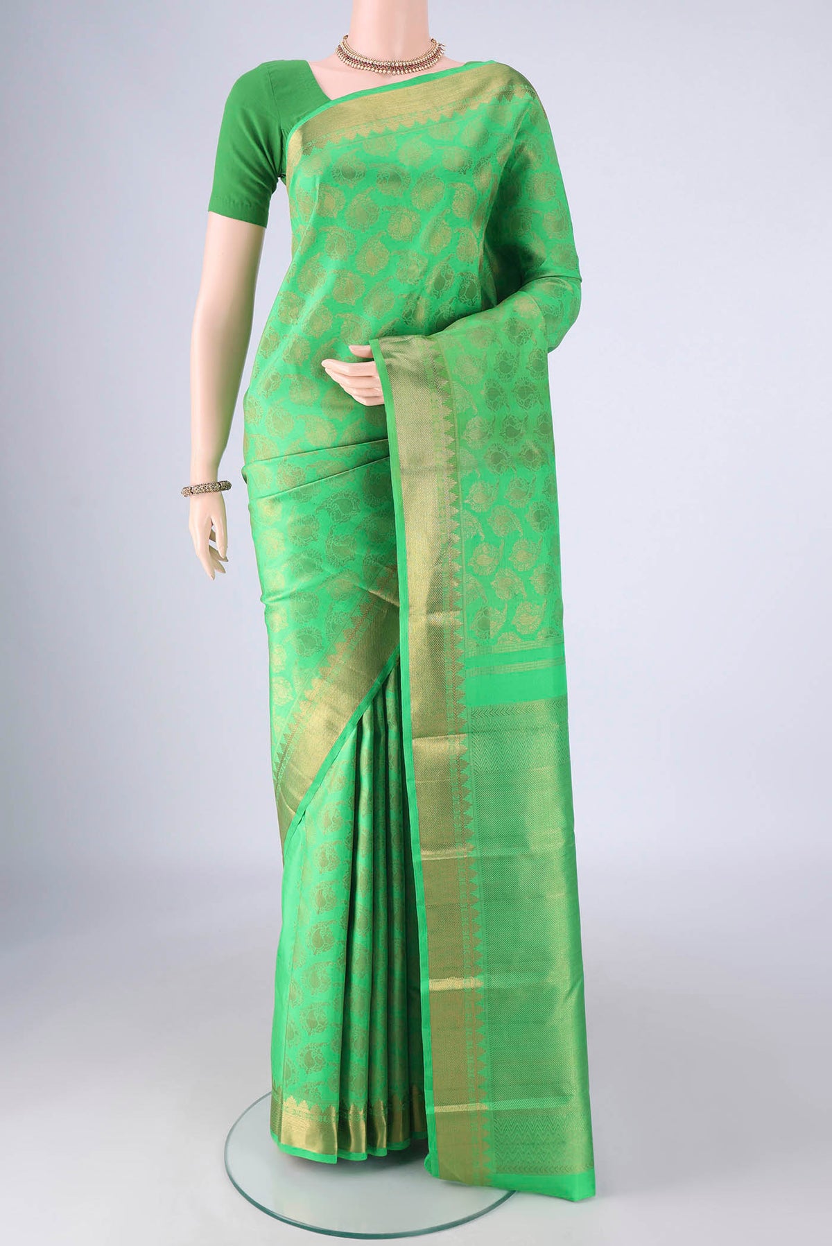 Pure Silk Pure Zari Green Kanjivaram Saree with Zari Brocade on the body and Zari Border.  displayed on a mannequin