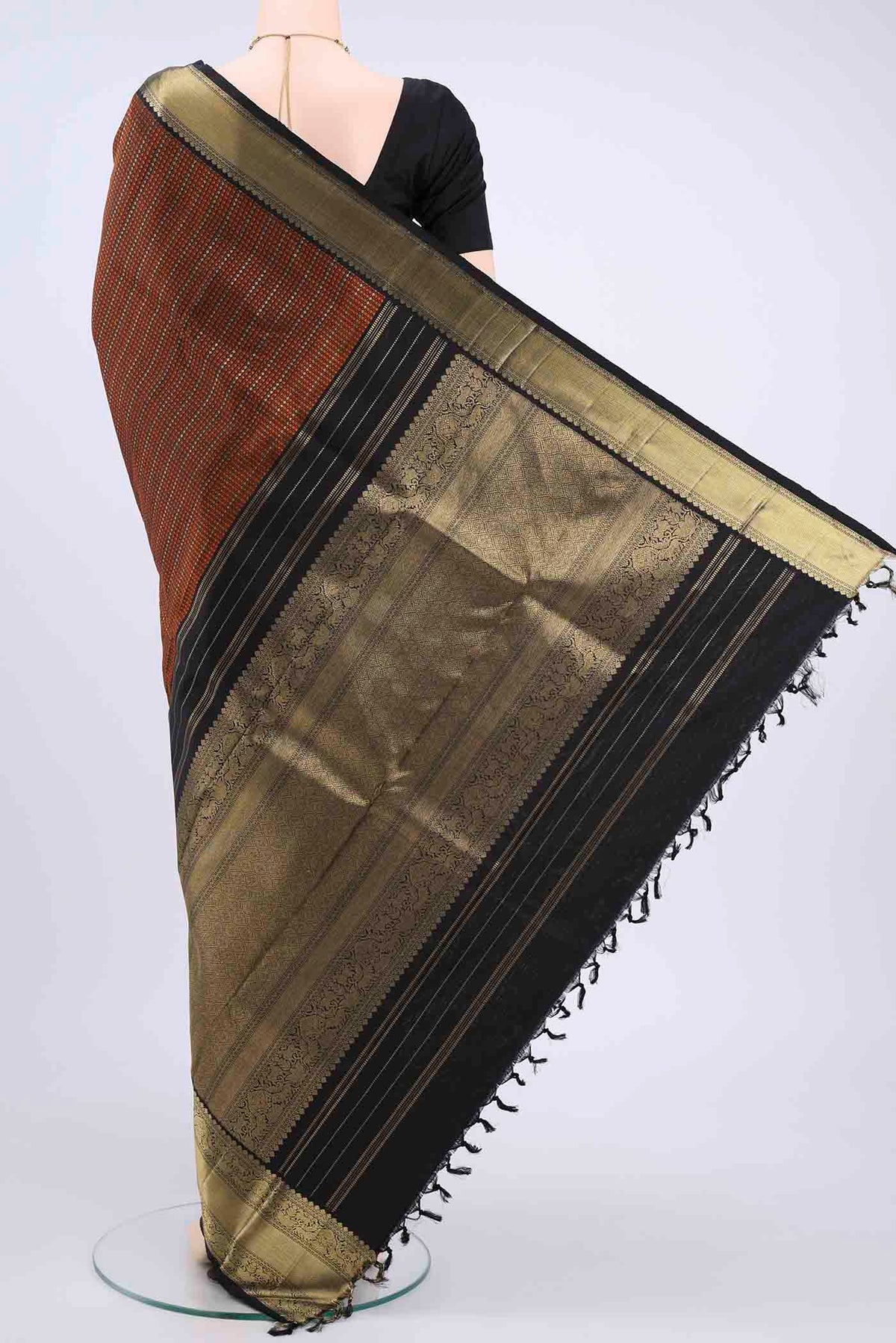 Flat view of Black Kanchipuram Saree with Zari Butta on the body and Zari Border