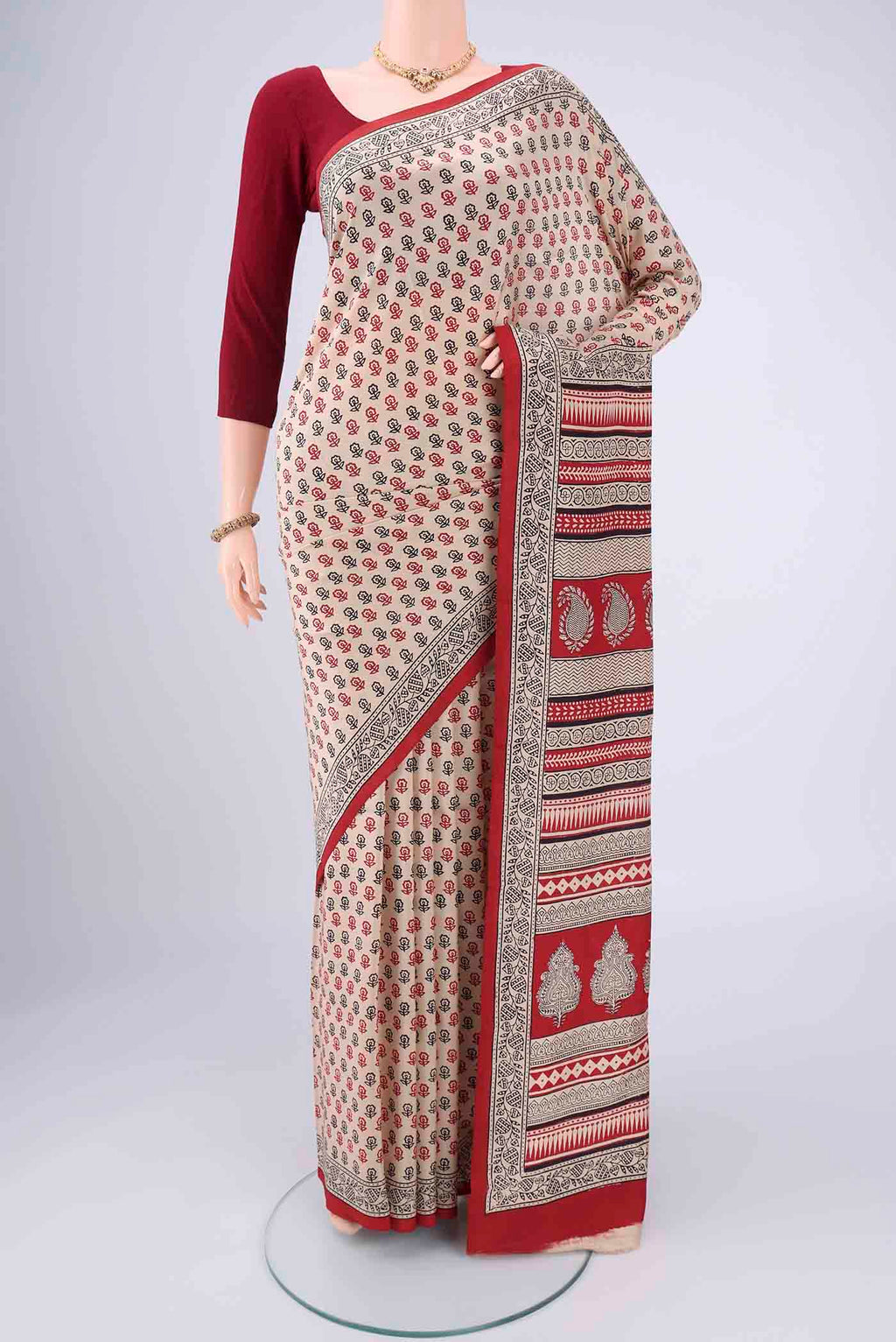 Beige Printed Silk Saree with Floral Print on the body and Printed Border.  displayed on a mannequin