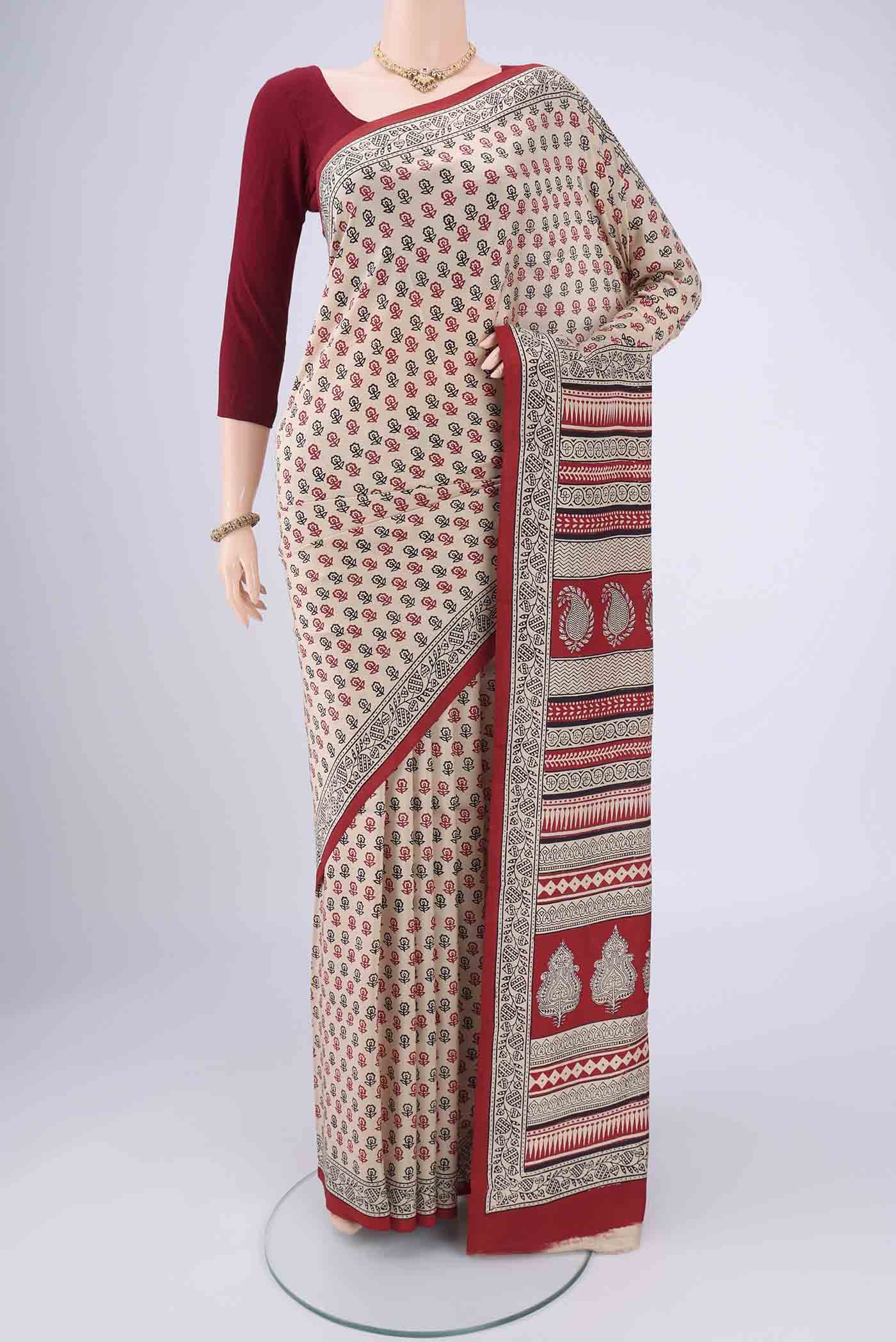 Beige Printed Silk Saree with Floral Print on the body and Printed Border.  displayed on a mannequin