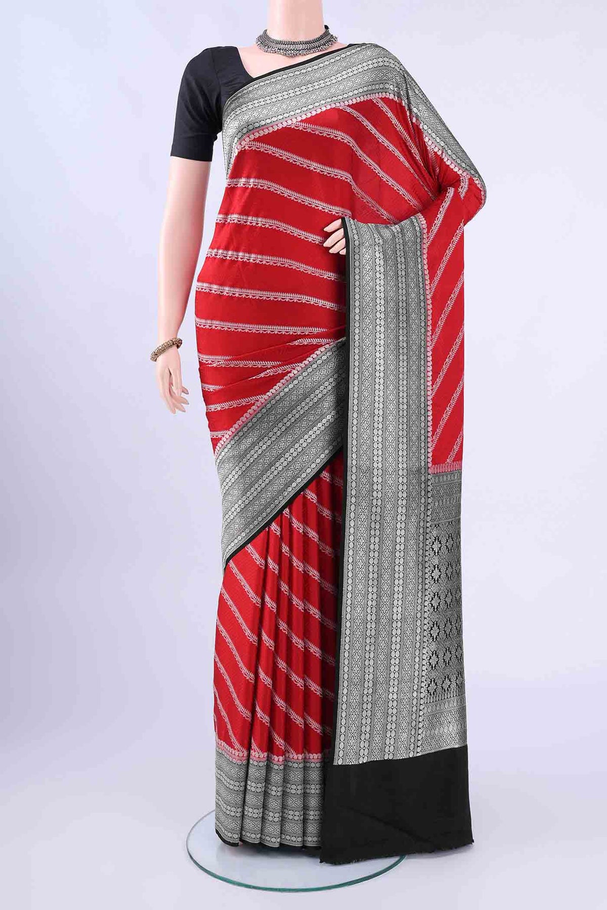 Red Banarasi SareeJacquard design on the body and Zari Border displayed on a mannequin