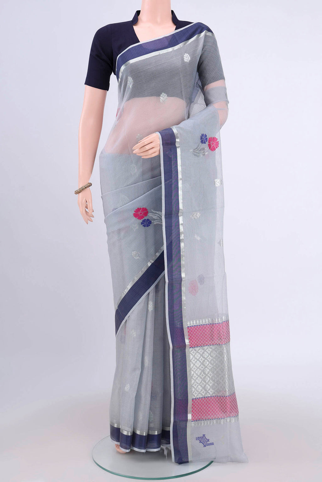 Pure Silk Pure Zari Grey Kota Cotton Saree with Zari And Thread Butta on the body and Zari Border.  displayed on a mannequin