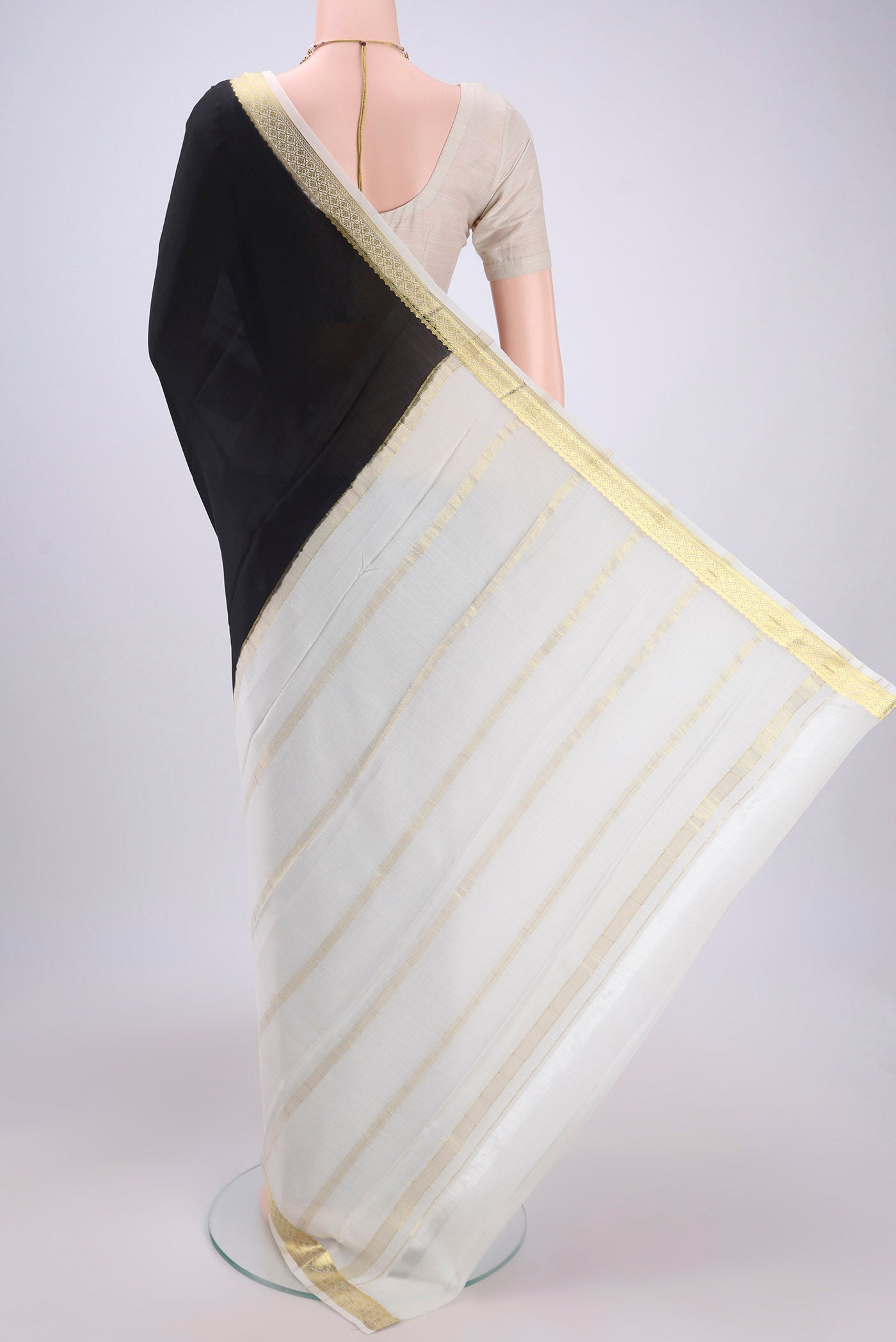 Flat view of Black Mysore Crepe Saree with Plain Body and Zari Border. 