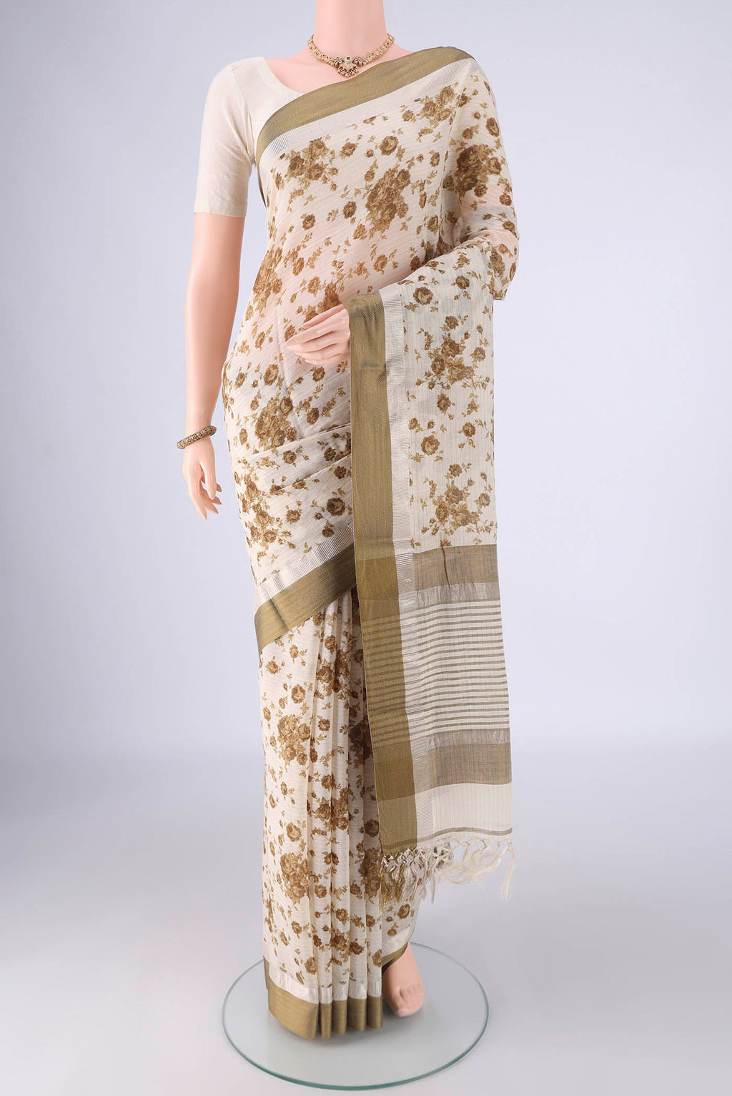 Off White Tussar Silk Saree with Floral Print on the body and Plain Border.  displayed on a mannequin
