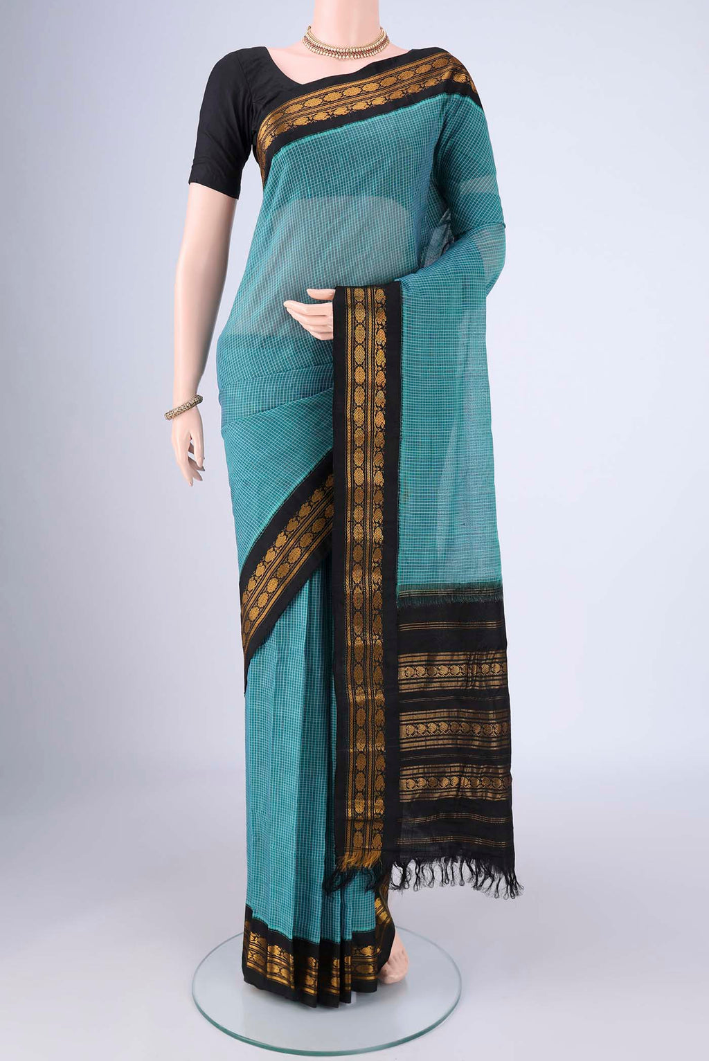 Blue Gadwal Silk Cotton Saree with Checked design on the body and Silk Border.  displayed on a mannequin