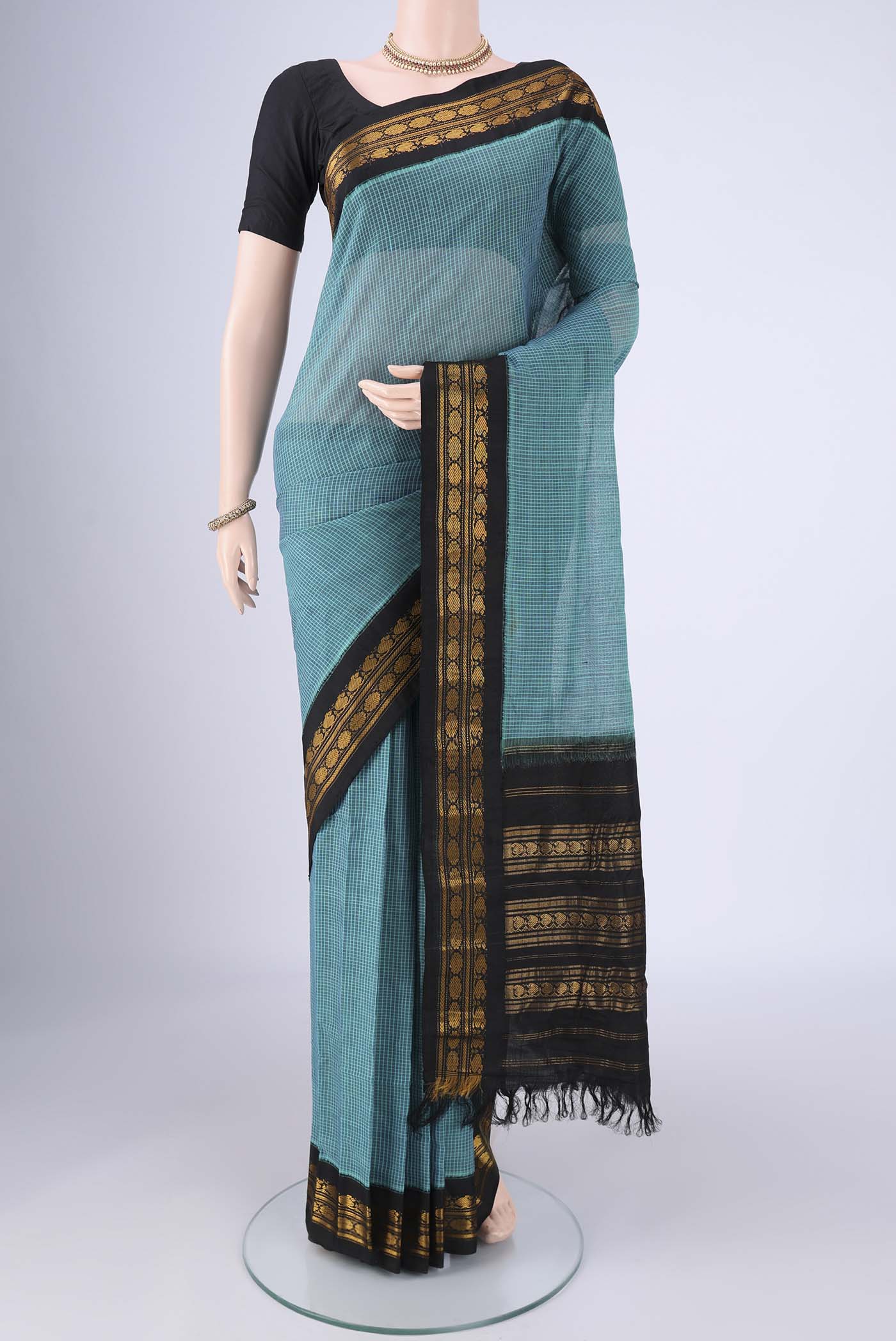Blue Gadwal Silk Cotton Saree with Checked design on the body and Silk Border.  displayed on a mannequin