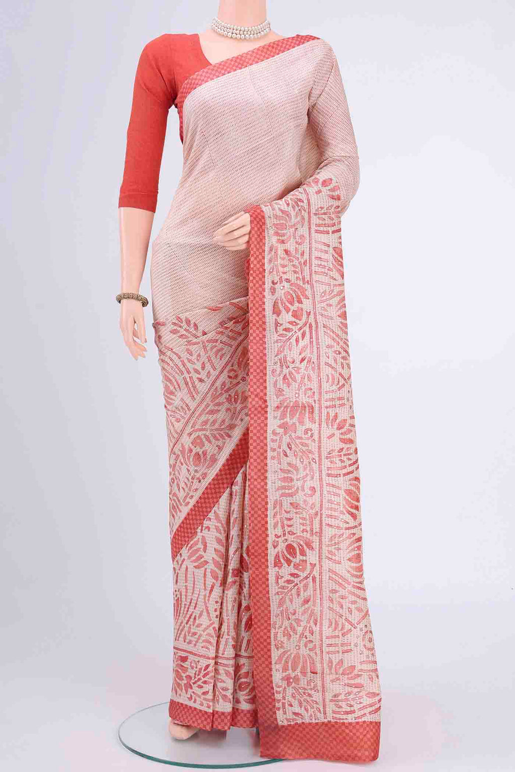Off White Printed Silk Saree with Embroidery on the body and Zari Border displayed on a mannequin