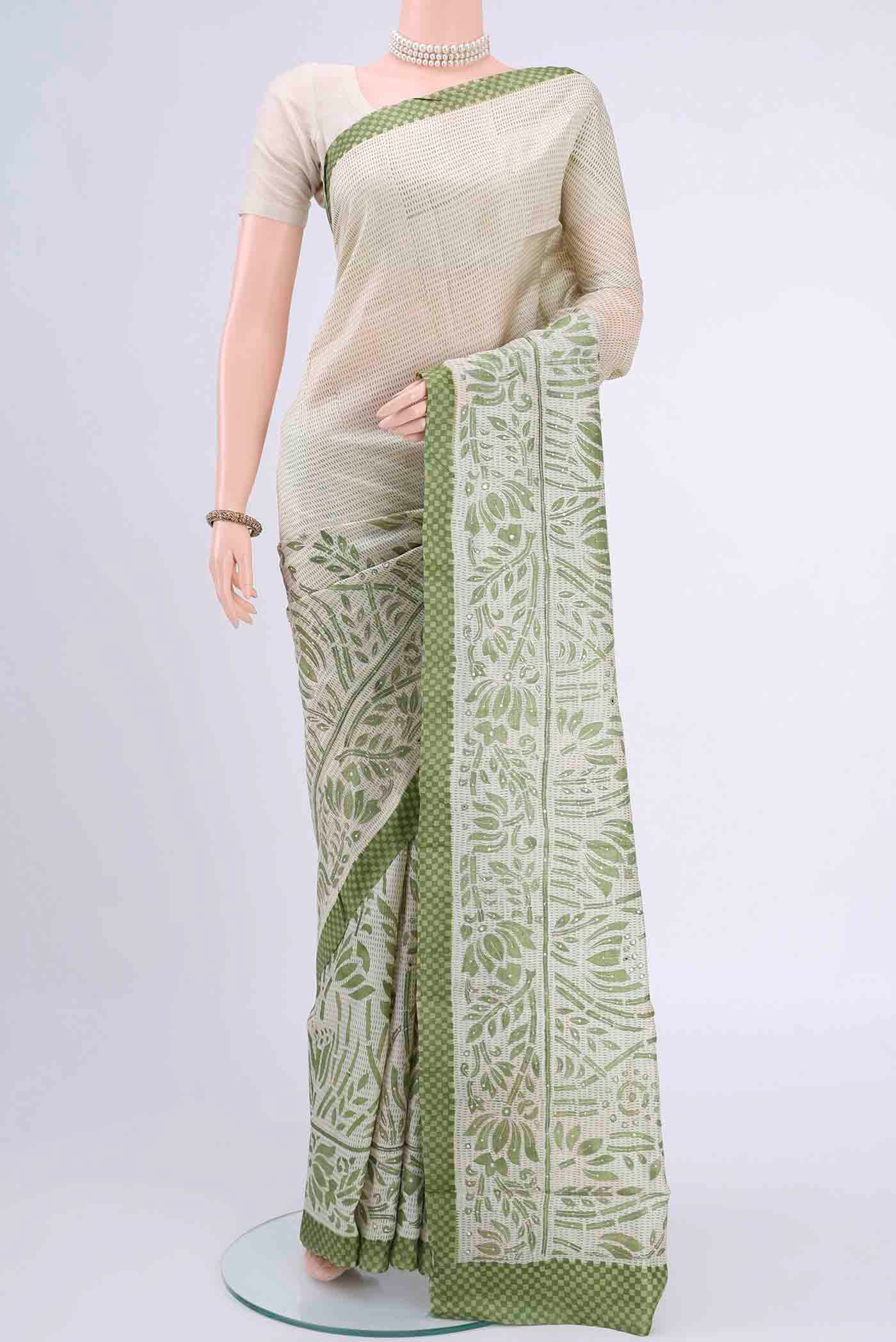 Off White Printed Silk Saree with Embroidery on the body and Zari Border displayed on a mannequin