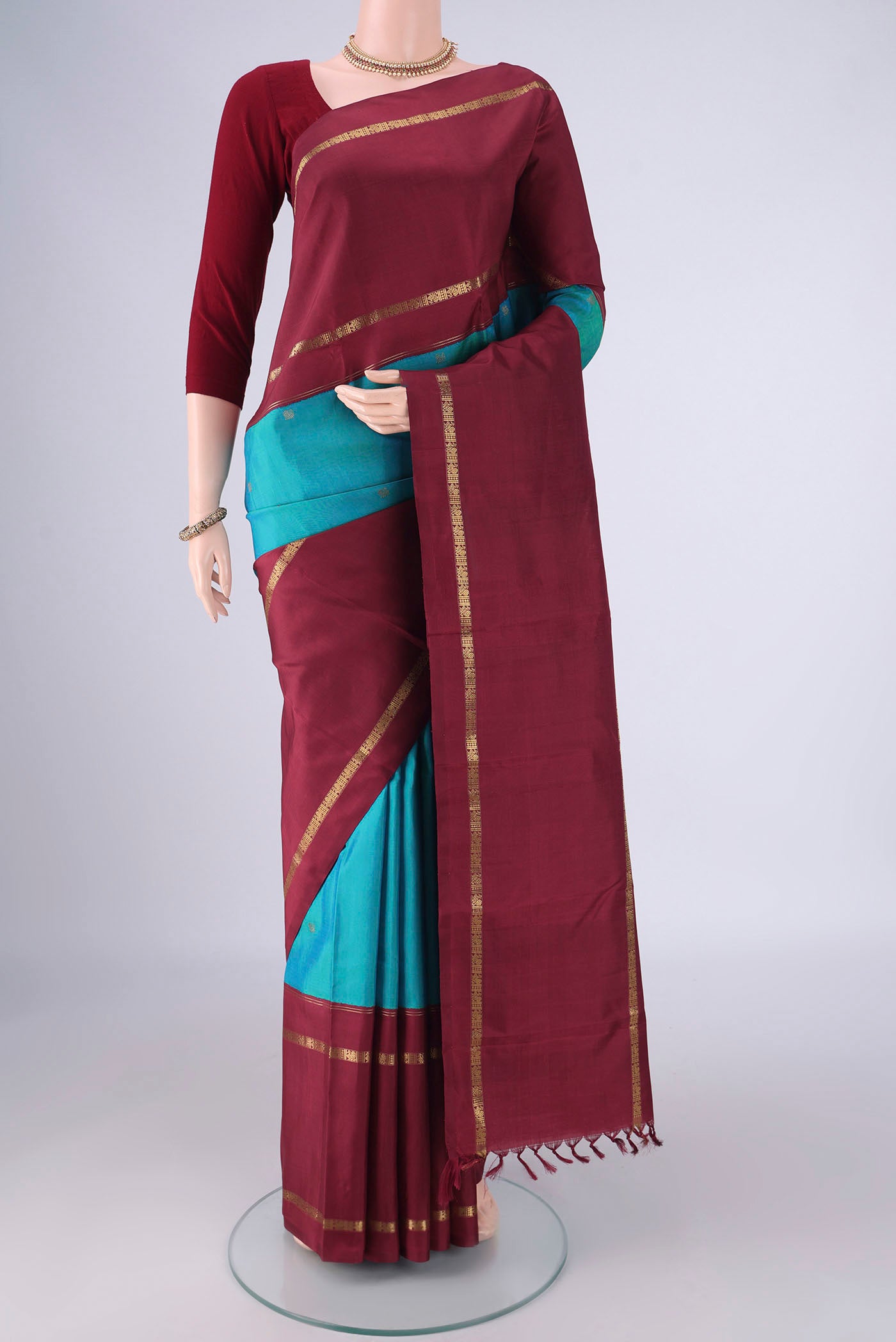 Pure Silk Pure Zari Blue Kanchipuram Saree with Zari Butta on the body and Zari Border.  displayed on a mannequin