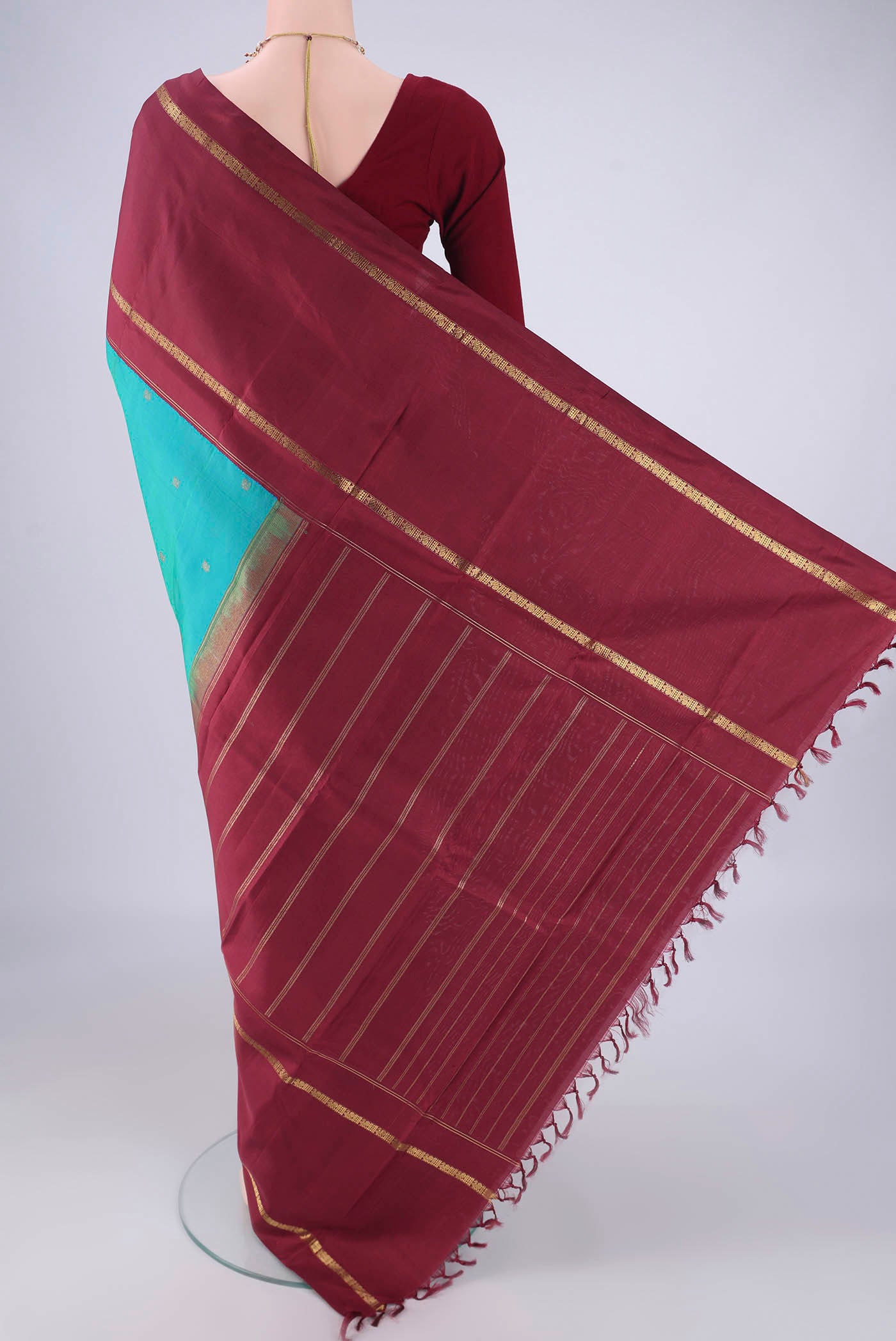 Flat view of Pure Silk Pure Zari Blue Kanchipuram Saree with Zari Butta on the body and Zari Border. 