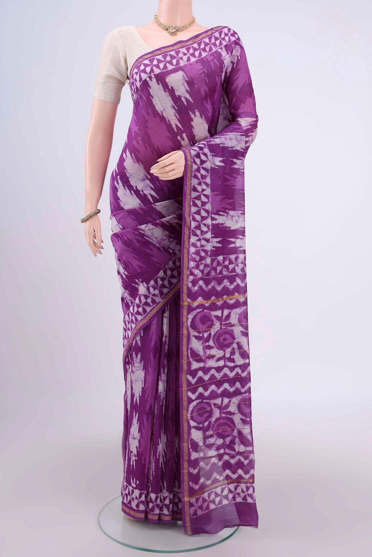 Magenta Chanderi Silk Cotton Saree with Printed design on the body and Zari Border.  displayed on a mannequin