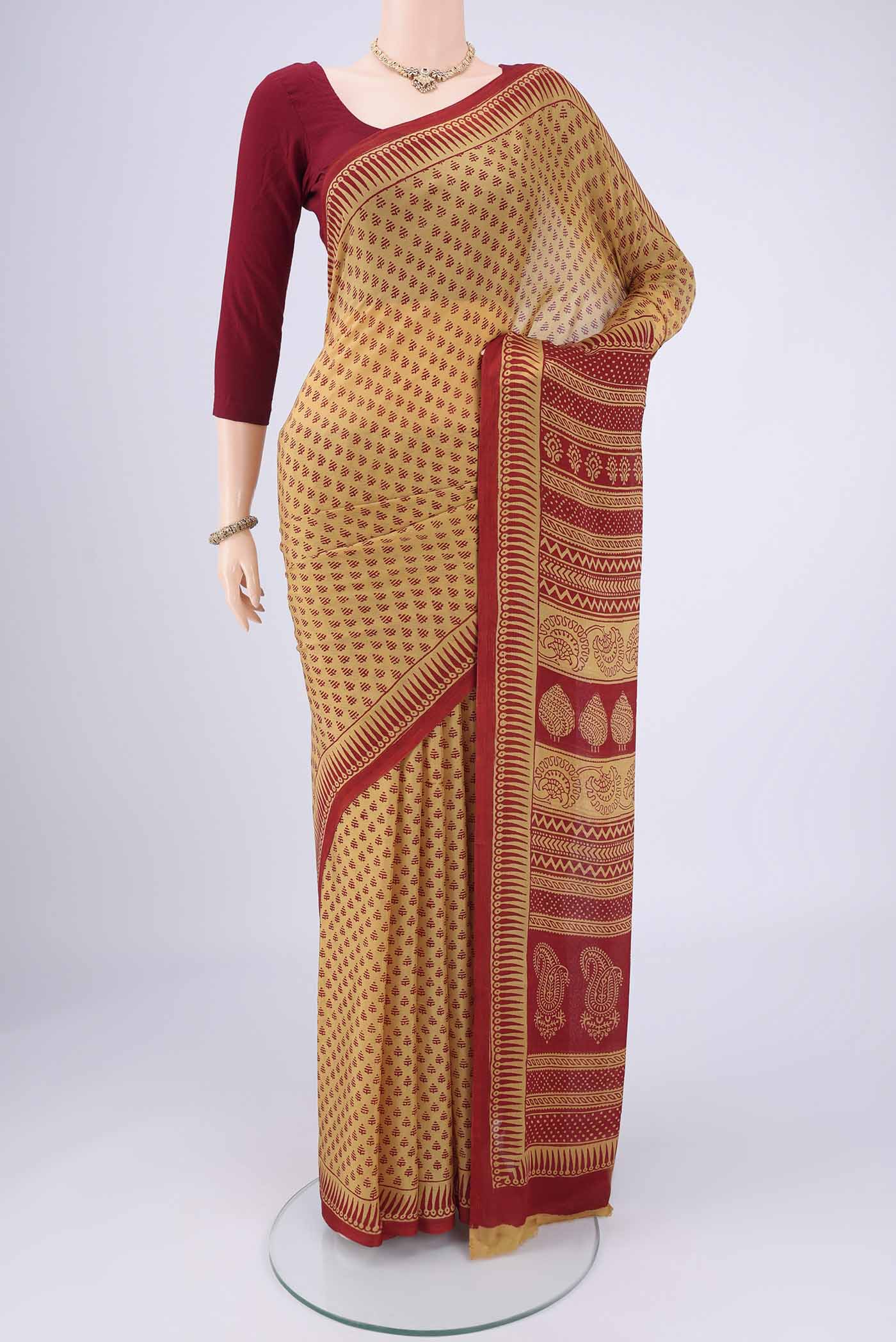 Mustard Mysore Chiffon Saree with Floral Print on the body and Printed Border.  displayed on a mannequin
