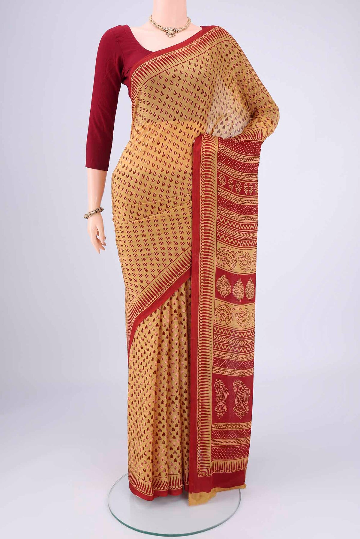 Mustard Mysore Chiffon Saree with Floral Print on the body and Printed Border.  displayed on a mannequin