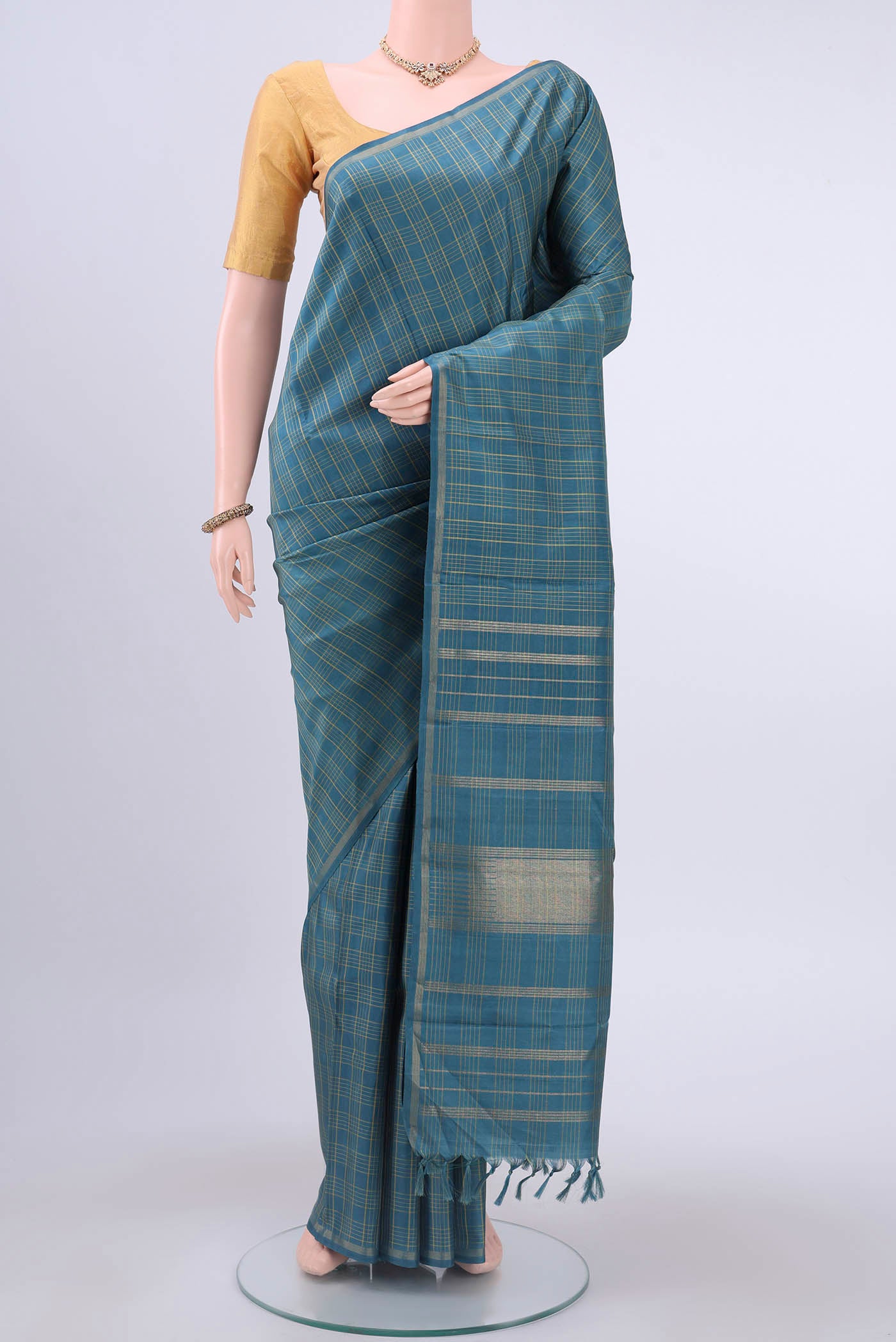 Pure Silk Pure Zari Light Blue Kanchipuram Saree with Checked design on the body and Zari Border displayed on a mannequin