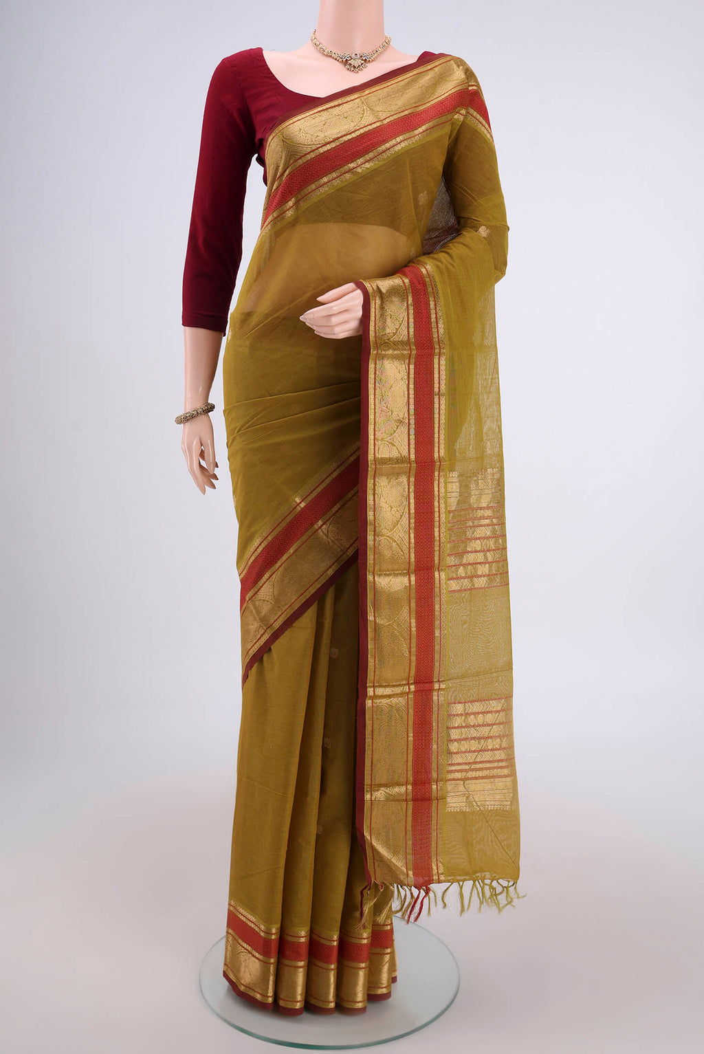Mehandi Green Kanchi Cotton Saree with Plain Body and Zari Border.  displayed on a mannequin