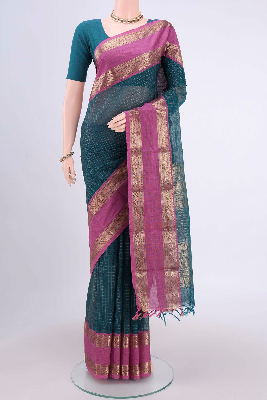 Green Kanchi Cotton Saree with Checked design on the body and Zari Border.  displayed on a mannequin