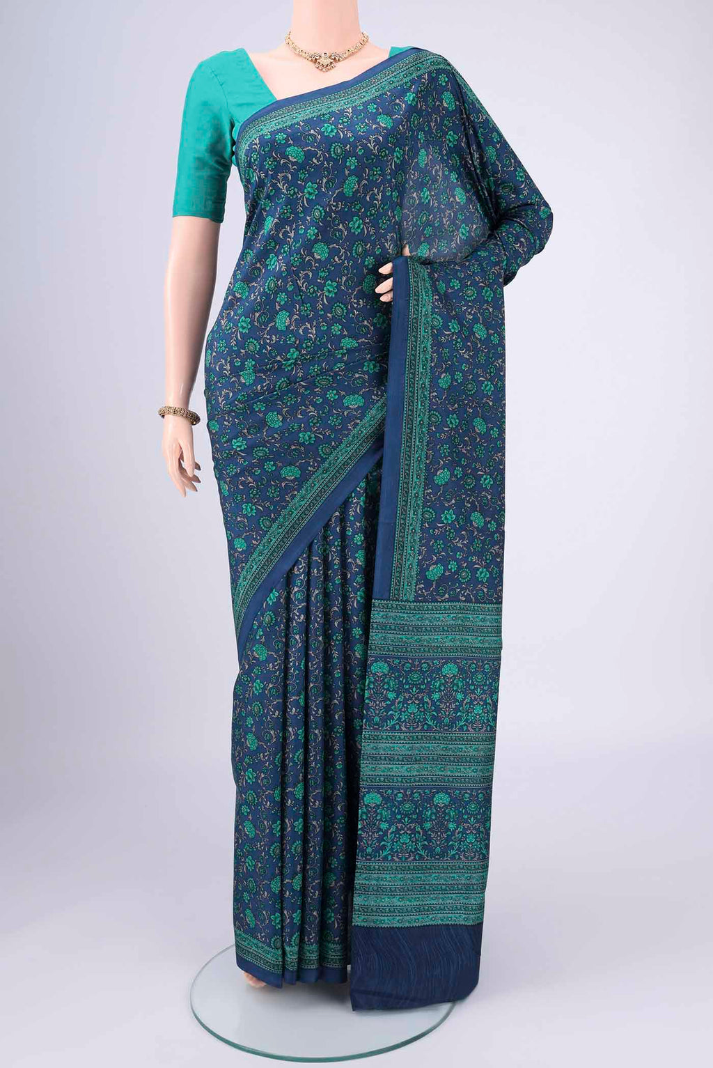 Navy Blue Printed Silk Saree with Floral Print on the body and Printed Border.  displayed on a mannequin