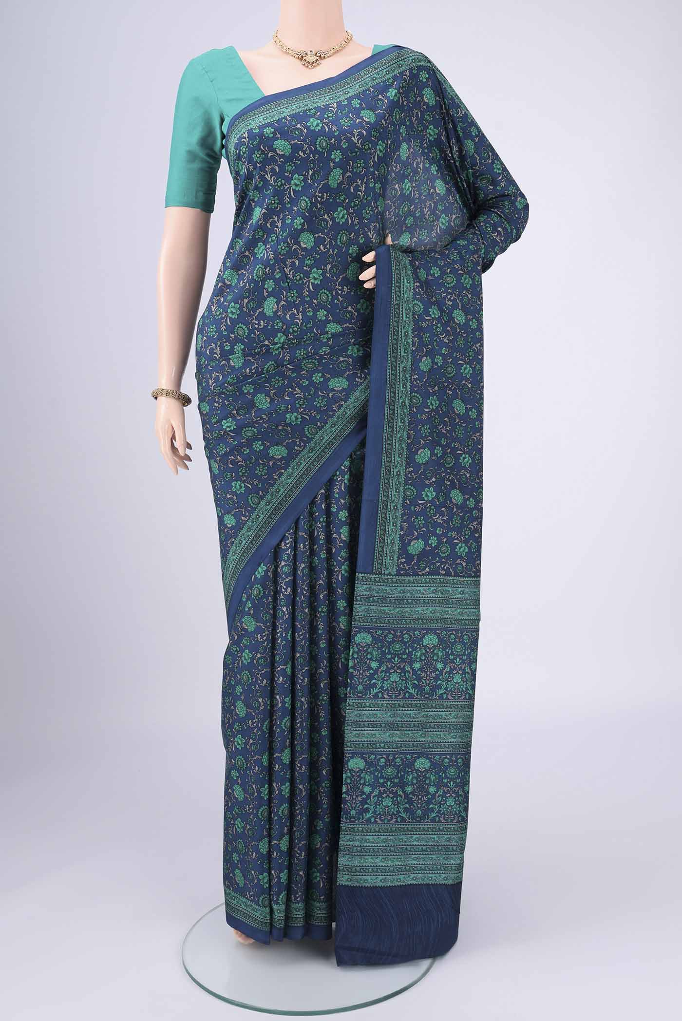 Navy Blue Printed Silk Saree with Floral Print on the body and Printed Border.  displayed on a mannequin