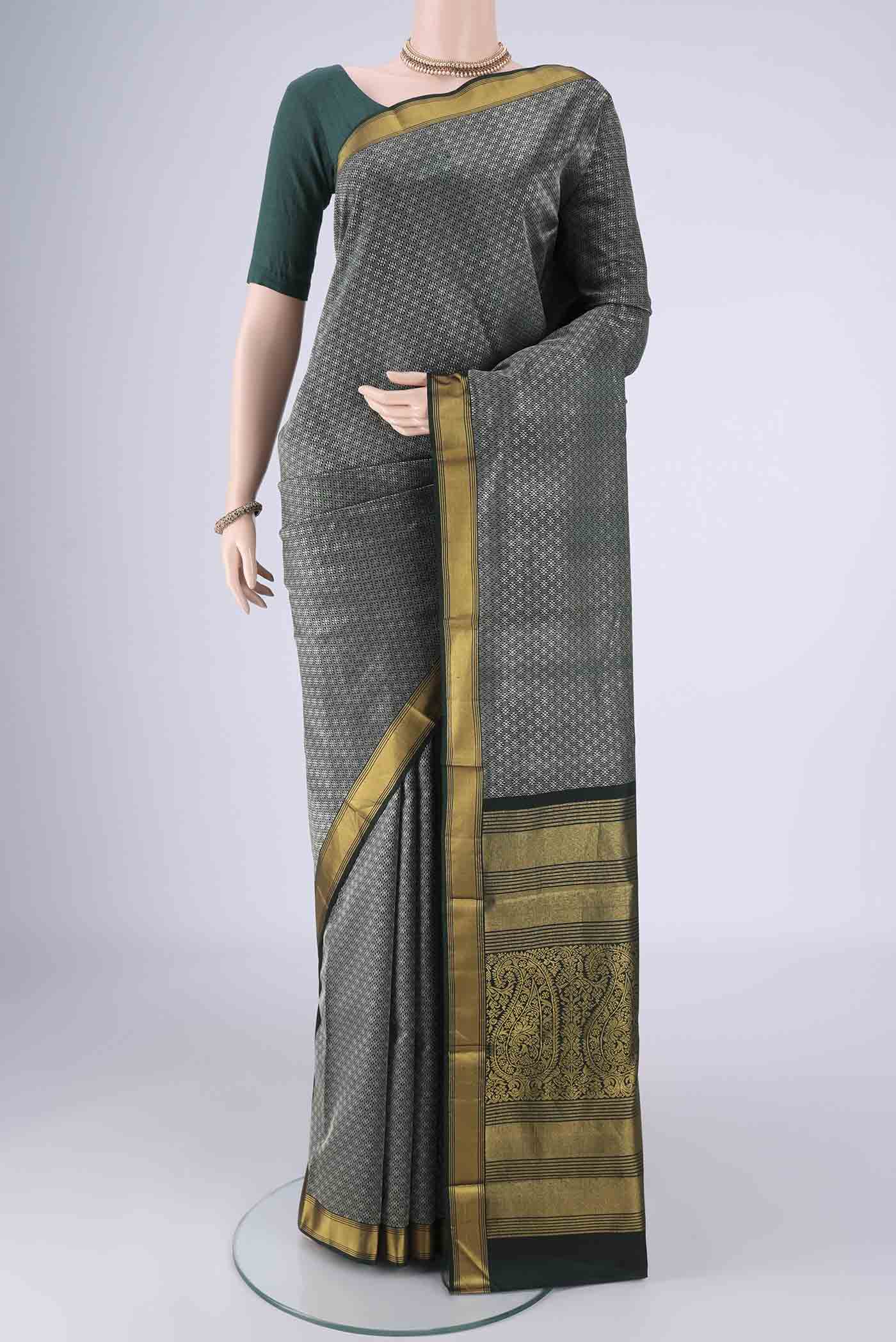 Bottle Green Kanjivaram Silk Saree with Jacquard design on the body and Zari Border.  displayed on a mannequin