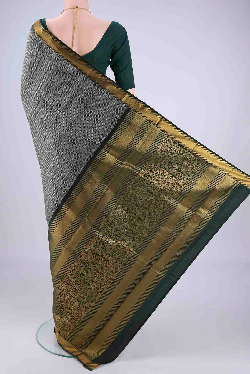 Flat view of Bottle Green Kanjivaram Silk Saree with Jacquard design on the body and Zari Border. 
