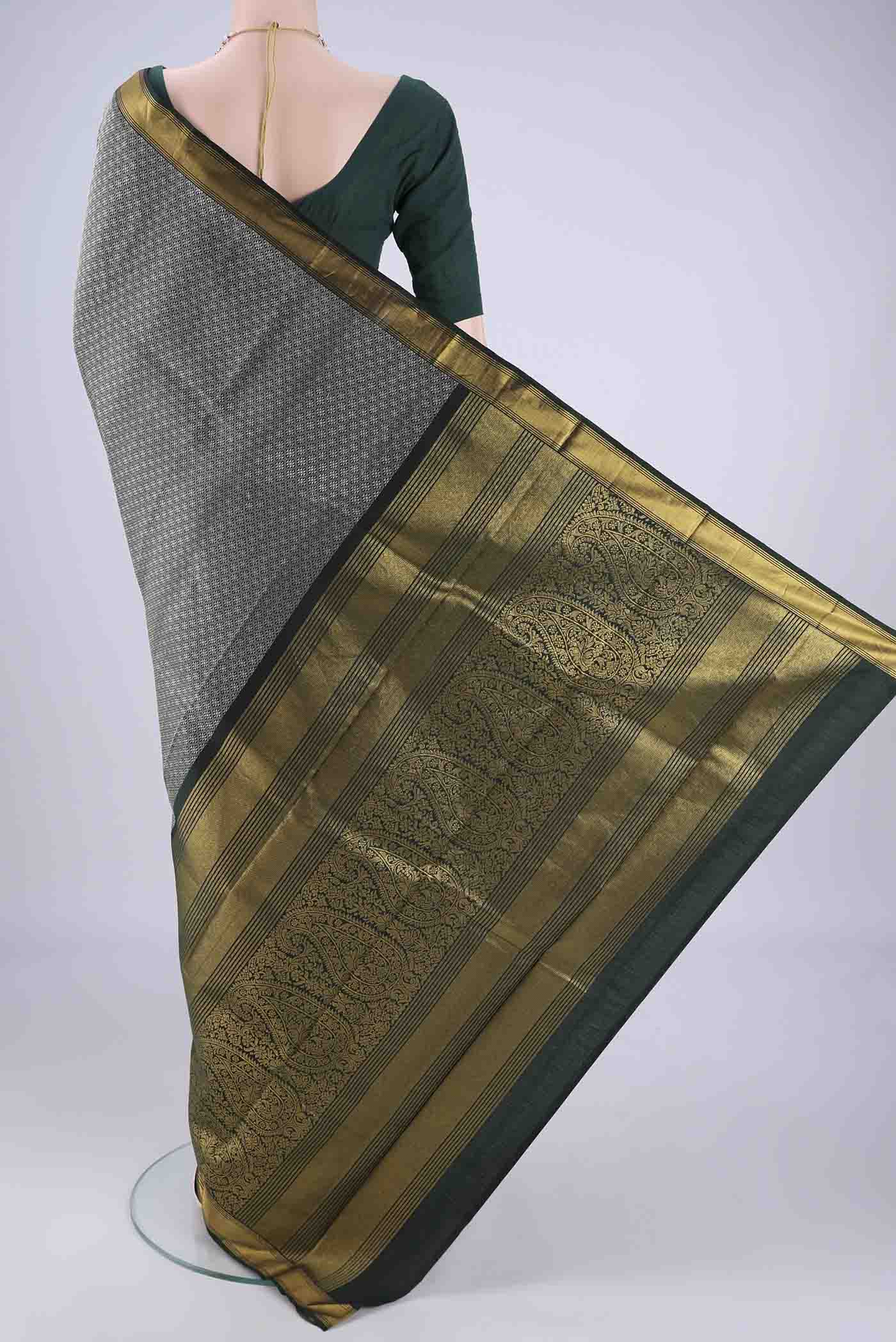 Flat view of Bottle Green Kanjivaram Silk Saree with Jacquard design on the body and Zari Border. 
