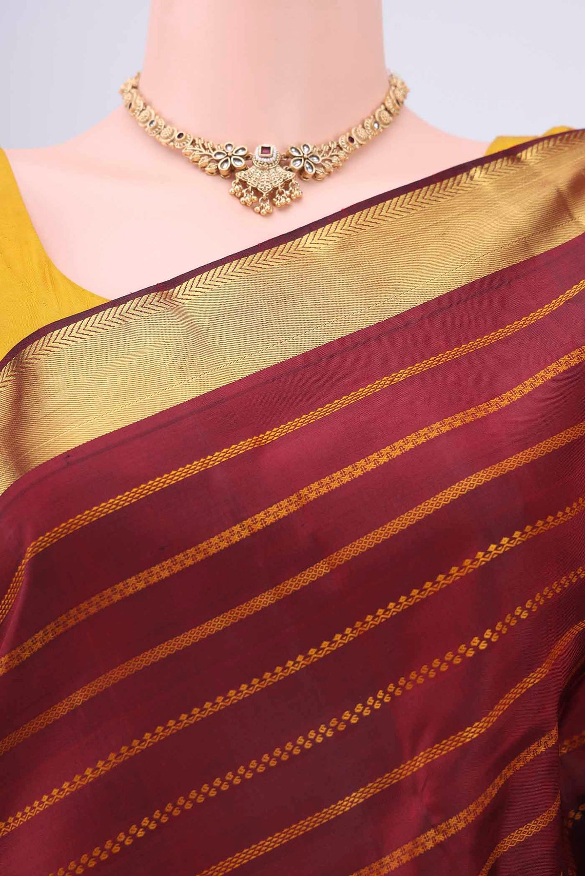 Border image of Pure Silk Pure Zari Maroon Kanchipuram Saree with Zari Butta on the body and Zari Border