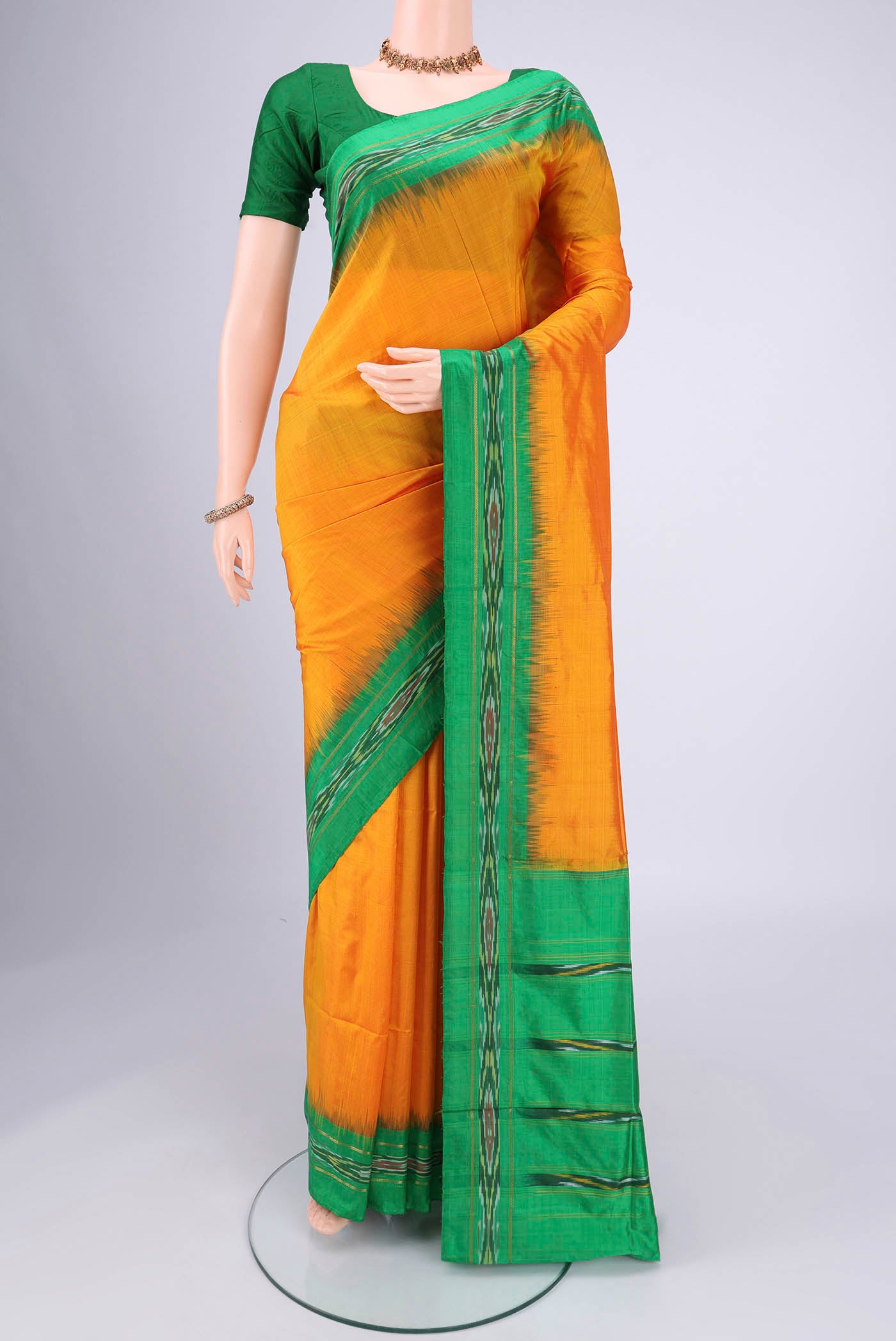 Yellow Pochampally Silk Saree with Plain Body and Ikat Border.  displayed on a mannequin