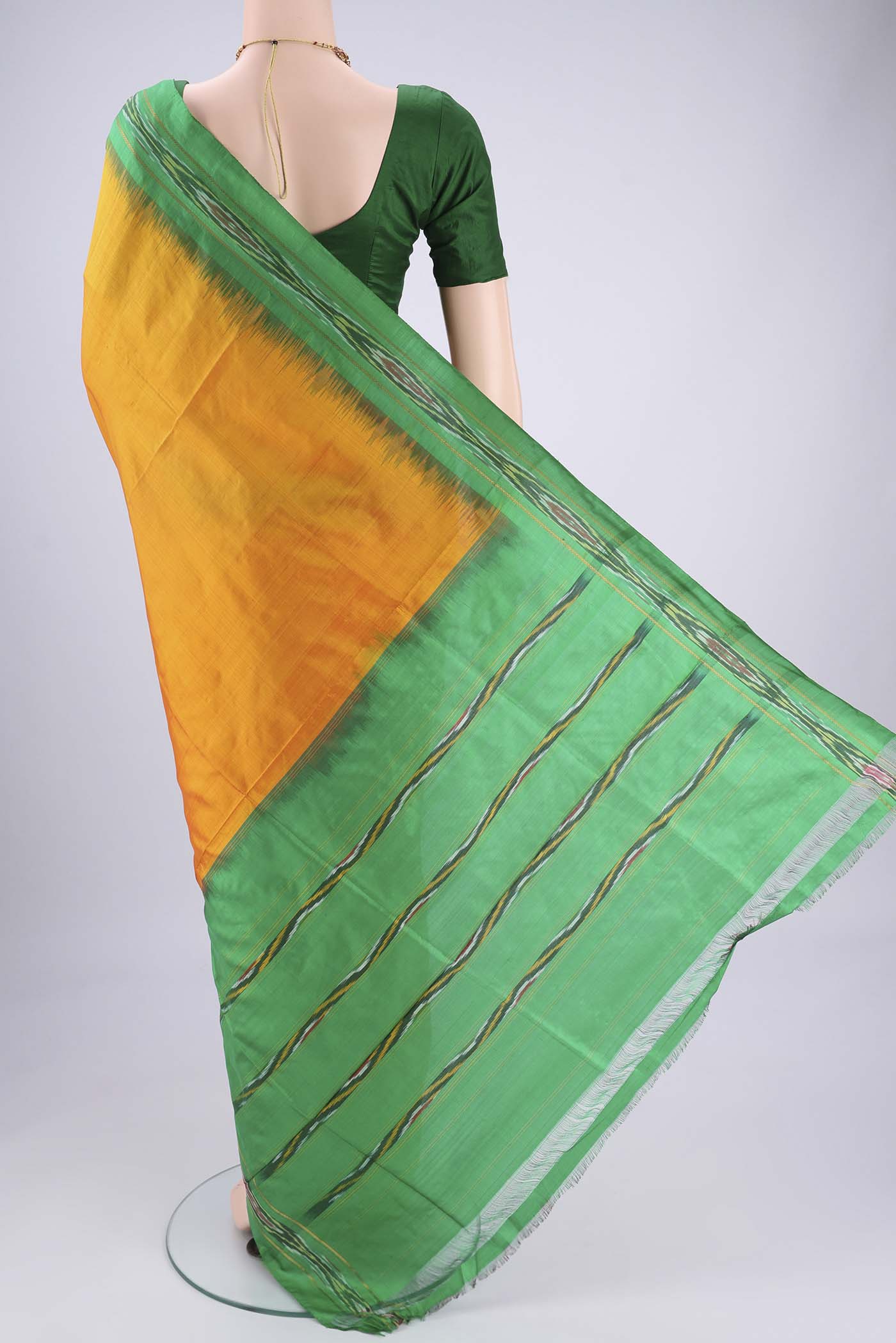 Flat view of Yellow Pochampally Silk Saree with Plain Body and Ikat Border. 