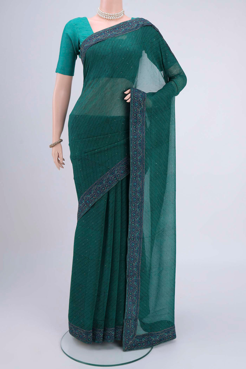 Green Mysore Chiffon Saree with Embroidery on the body and Embroidery Border.  displayed on a mannequin