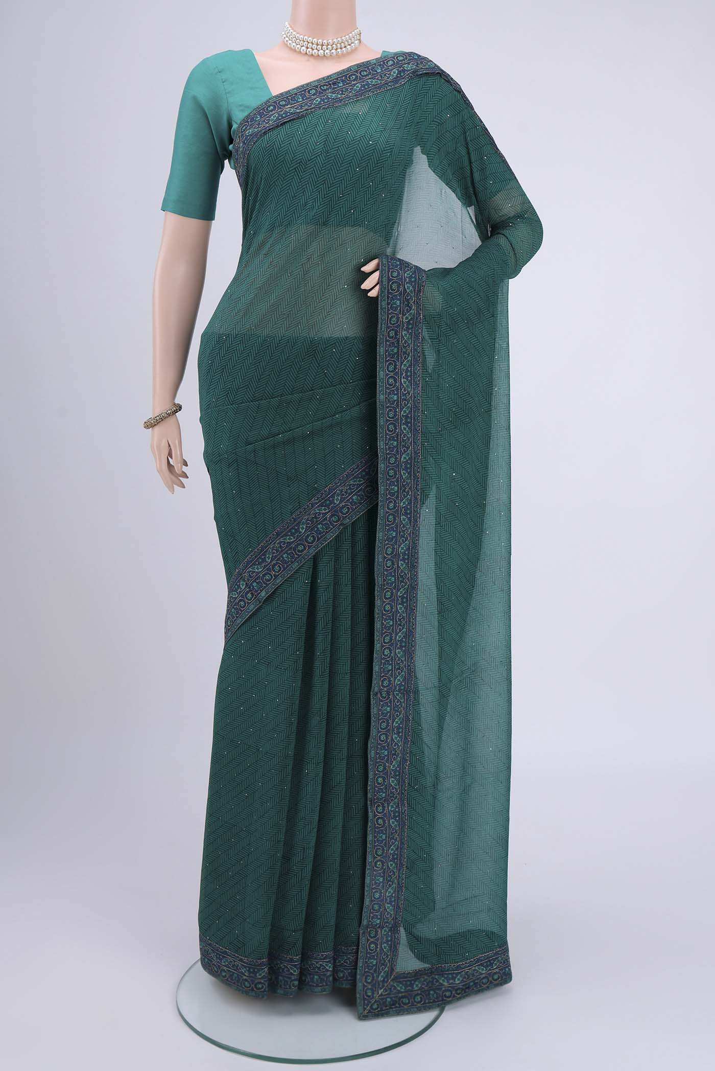 Green Mysore Chiffon Saree with Embroidery on the body and Embroidery Border.  displayed on a mannequin