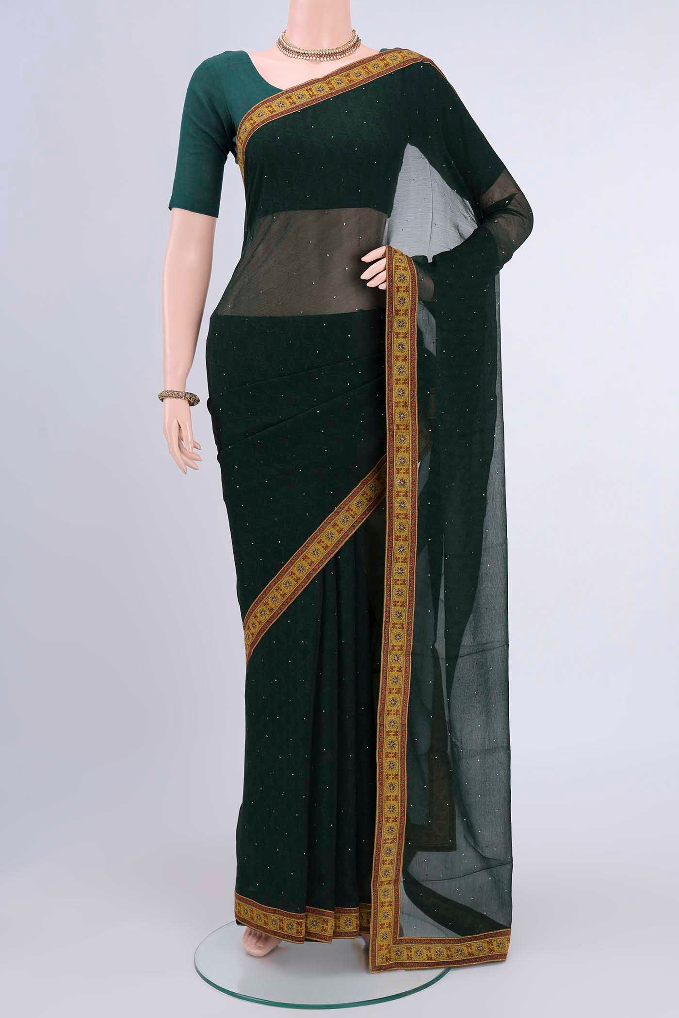 Bottle Green Chiffon Saree with Printed design on the body and Attached Border displayed on a mannequin