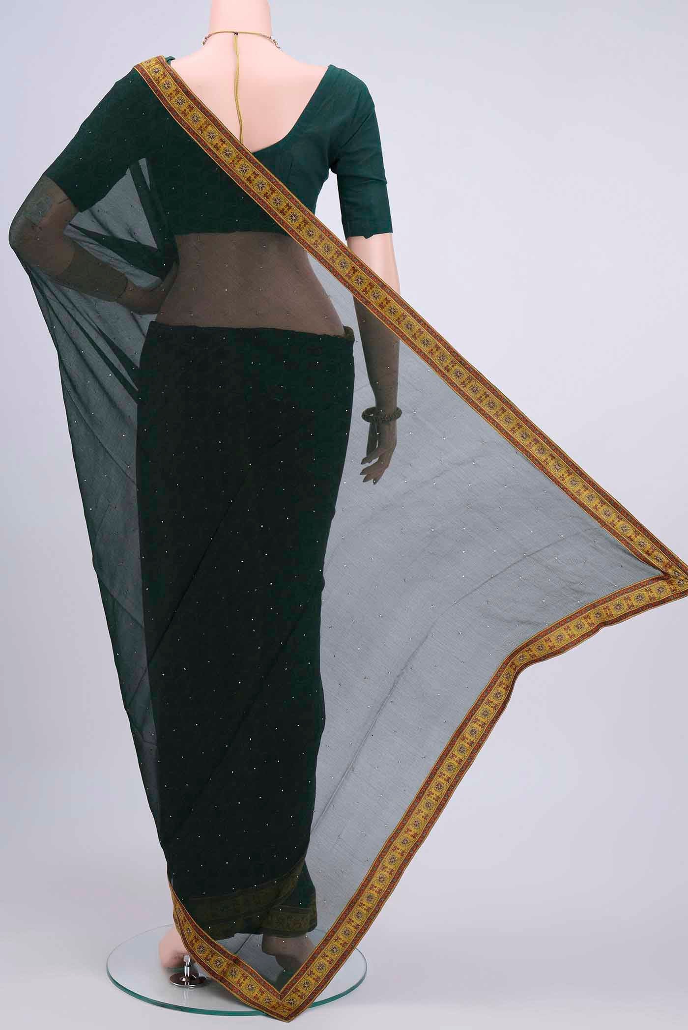 Flat view of Bottle Green Chiffon Saree with Printed design on the body and Attached Border