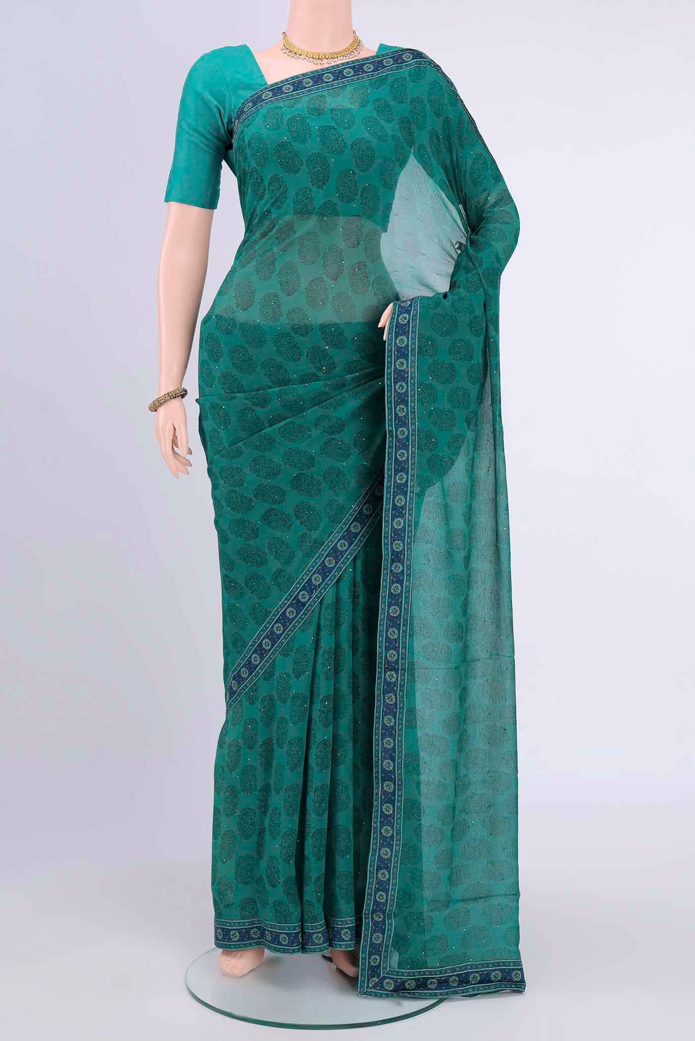 Sea Green Chiffon Saree with Printed design on the body and Attached Border displayed on a mannequin